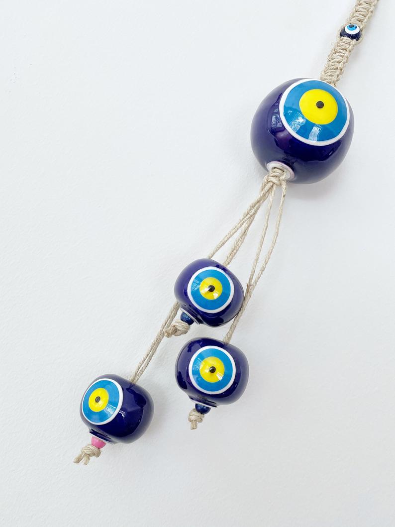 Elegant Ceramic Ball Wall Hanging featuring Turkish evil eye design, handmade with vibrant colors and unique craftsmanship.