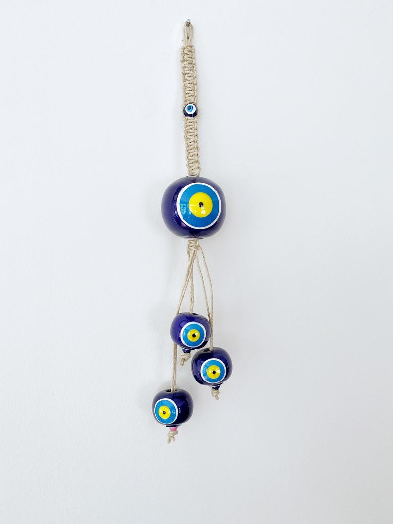Elegant Ceramic Ball Wall Hanging featuring Turkish evil eye design, handmade with vibrant colors and unique craftsmanship.