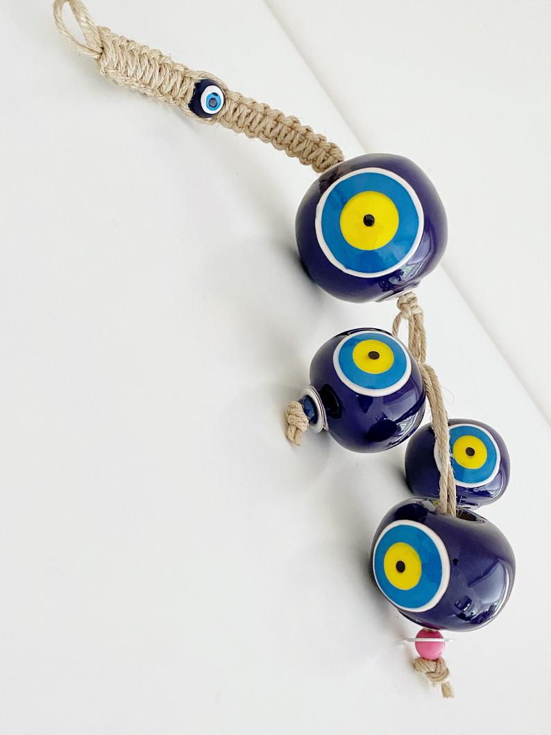 Elegant Ceramic Ball Wall Hanging featuring Turkish evil eye design, handmade with vibrant colors and unique craftsmanship.