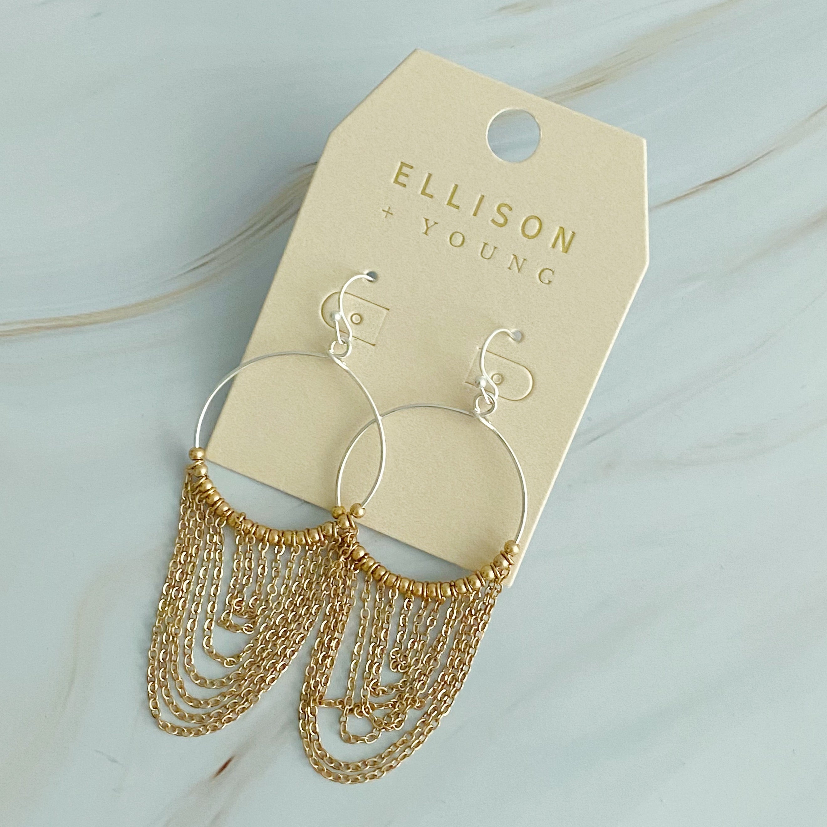 Elegant Chain Drapes Two Tone Earrings featuring gold and silver draping chains and slim hoops.
