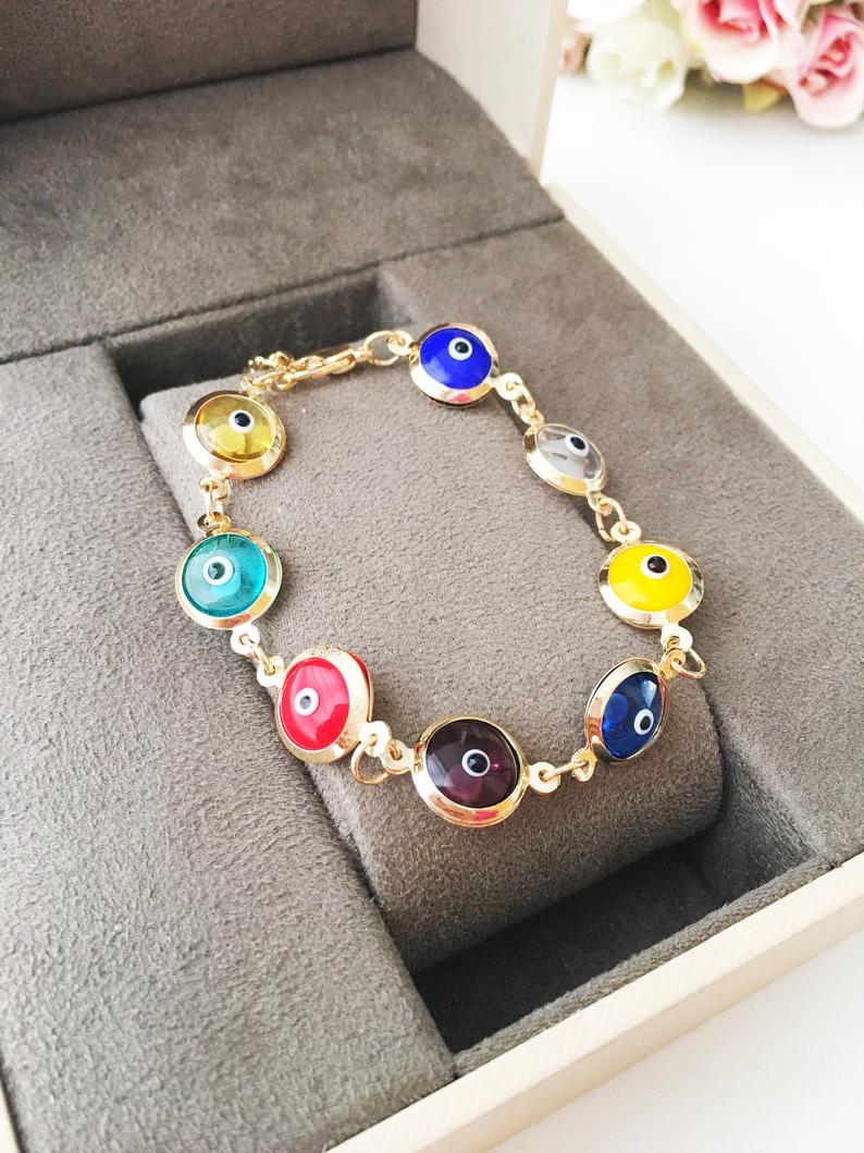 Colorful chain link bracelet featuring 12mm glass evil eye beads in a rainbow pattern, showcasing a blend of vibrant colors.