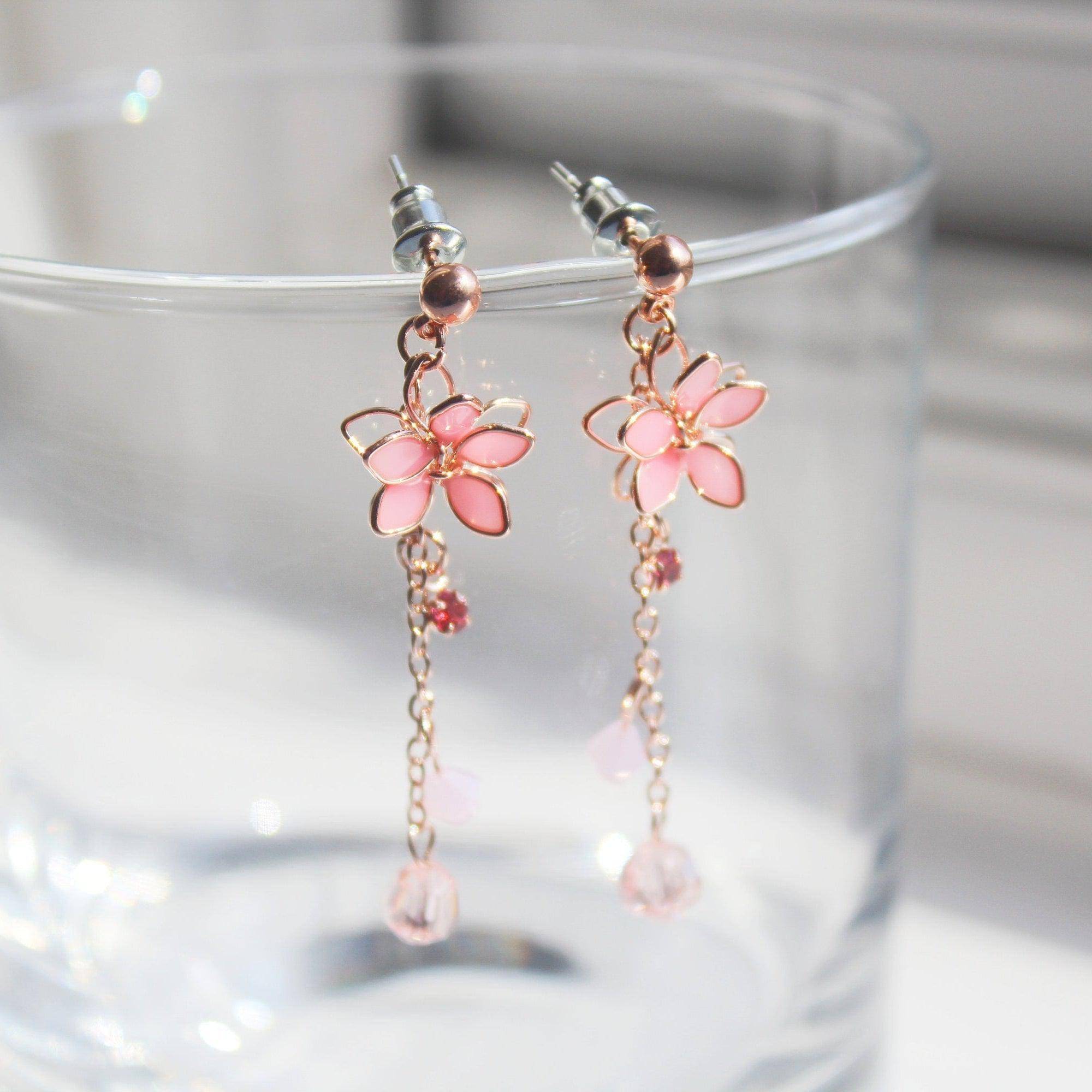 Handmade pink five-petal flower dangle drop earrings with rose gold wire and sterling silver studs, elegantly displayed in a gift box.
