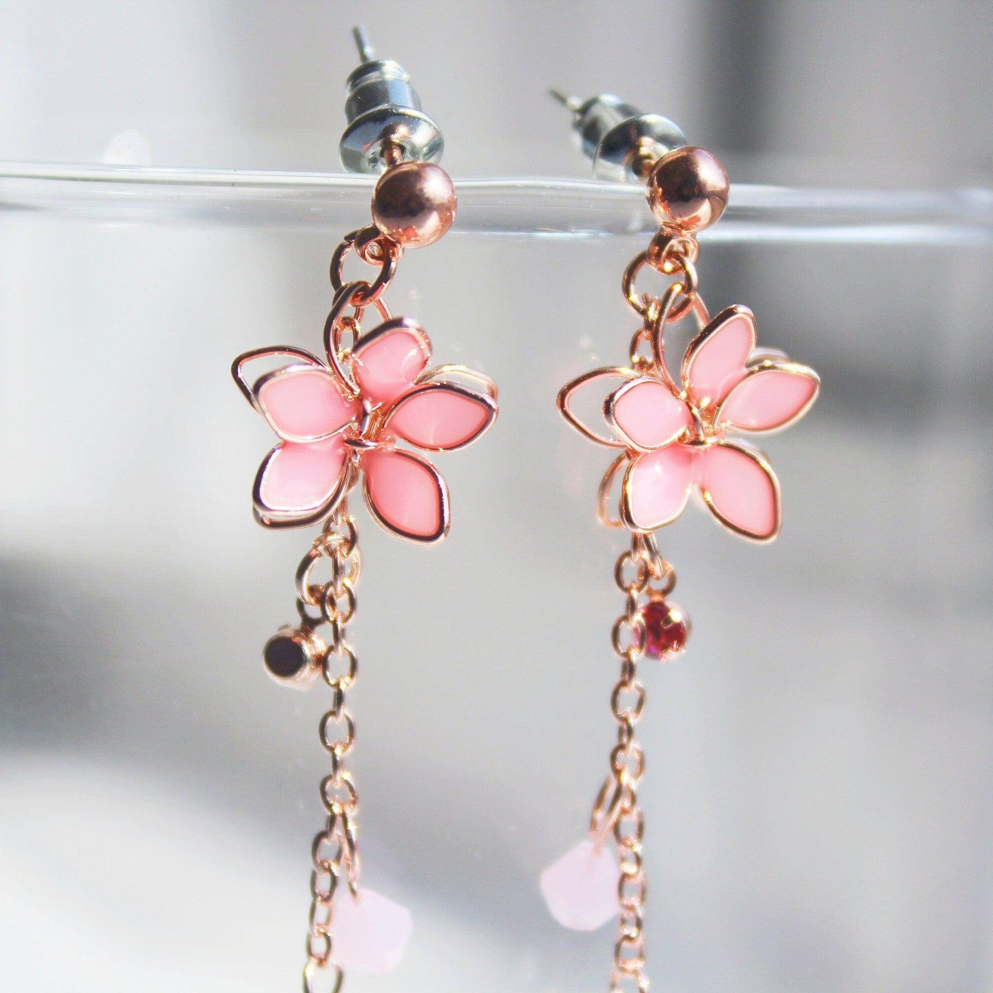 Handmade pink five-petal flower dangle drop earrings with rose gold wire and sterling silver studs, elegantly displayed in a gift box.