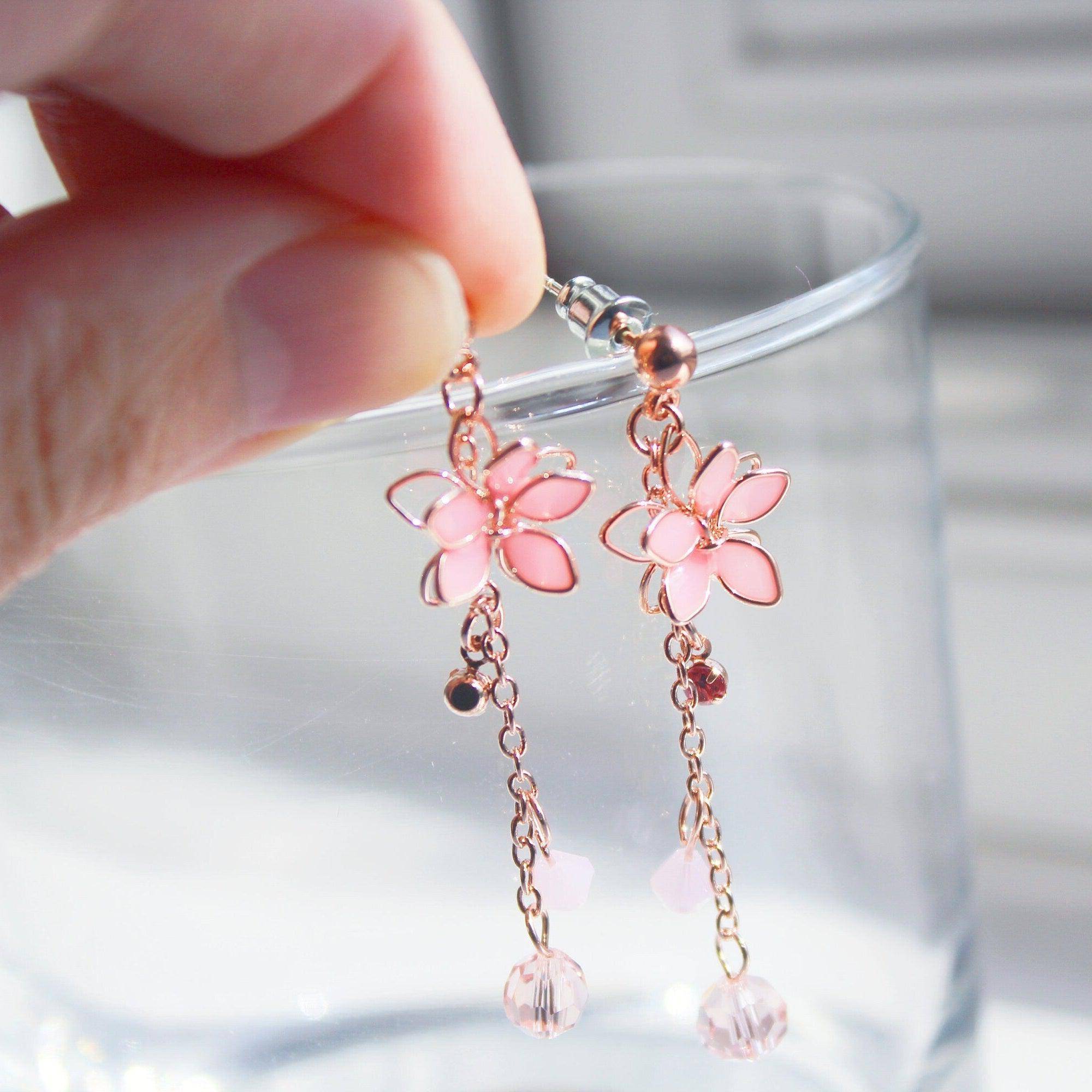 Handmade pink five-petal flower dangle drop earrings with rose gold wire and sterling silver studs, elegantly displayed in a gift box.