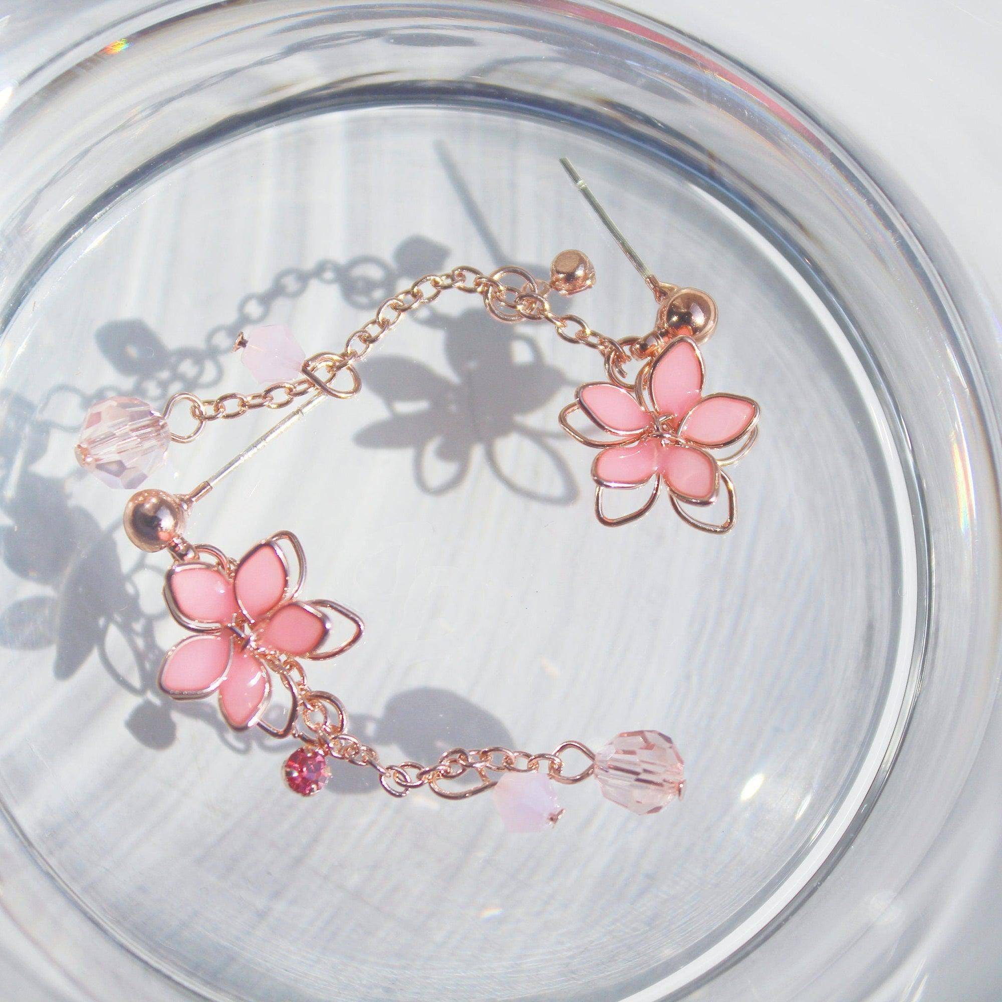 Handmade pink five-petal flower dangle drop earrings with rose gold wire and sterling silver studs, elegantly displayed in a gift box.