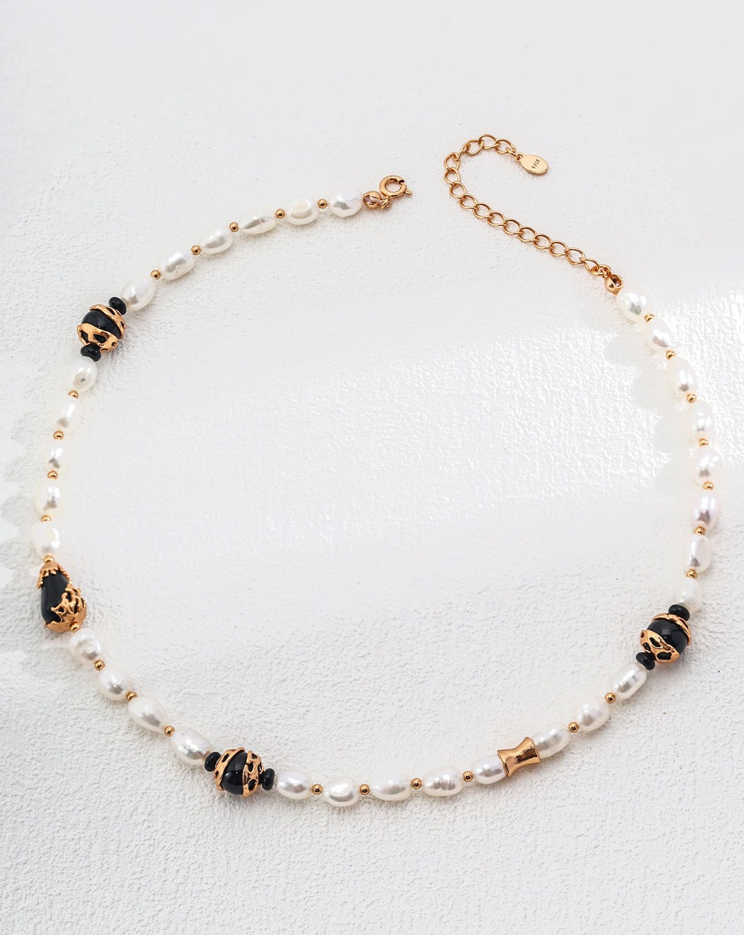 Chic Pure Silver Pearl Necklace featuring elegant white pearls and striking black onyx, showcasing a sophisticated design.