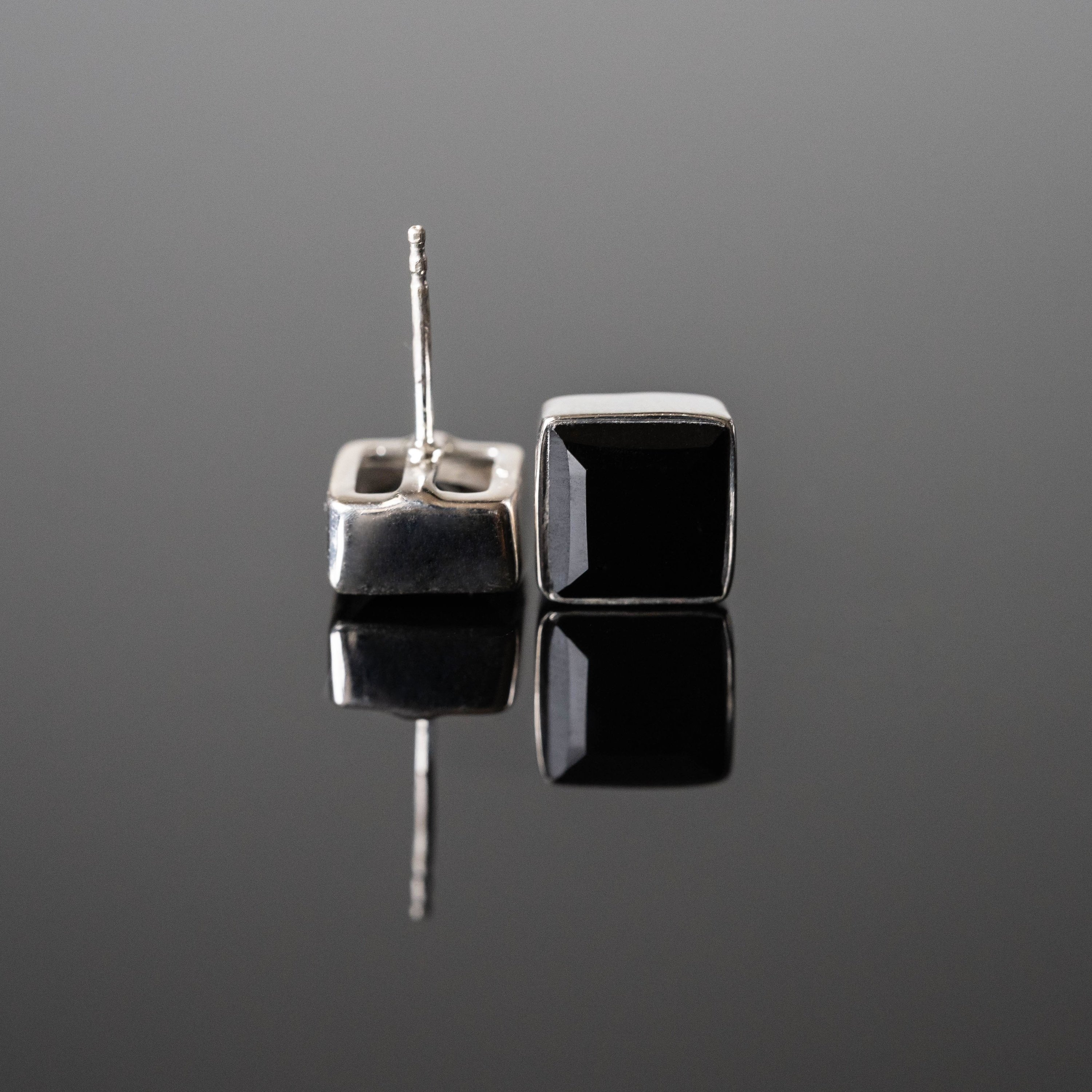 Clara Black Onyx Square Studs made of 925 sterling silver with rhodium plating, featuring 8 mm black onyx stones, elegantly displayed in gift-ready packaging.