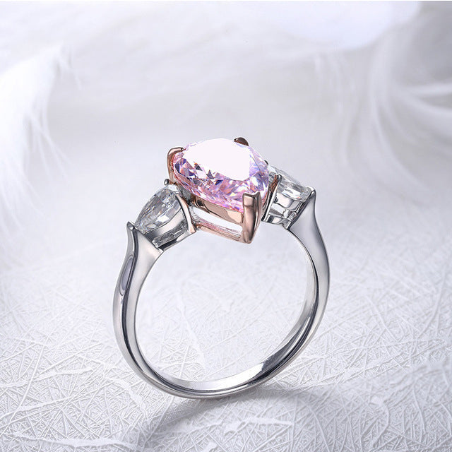 Classic sterling silver ring with white sapphire and pear-shaped pink cz, showcasing elegance and sparkle.