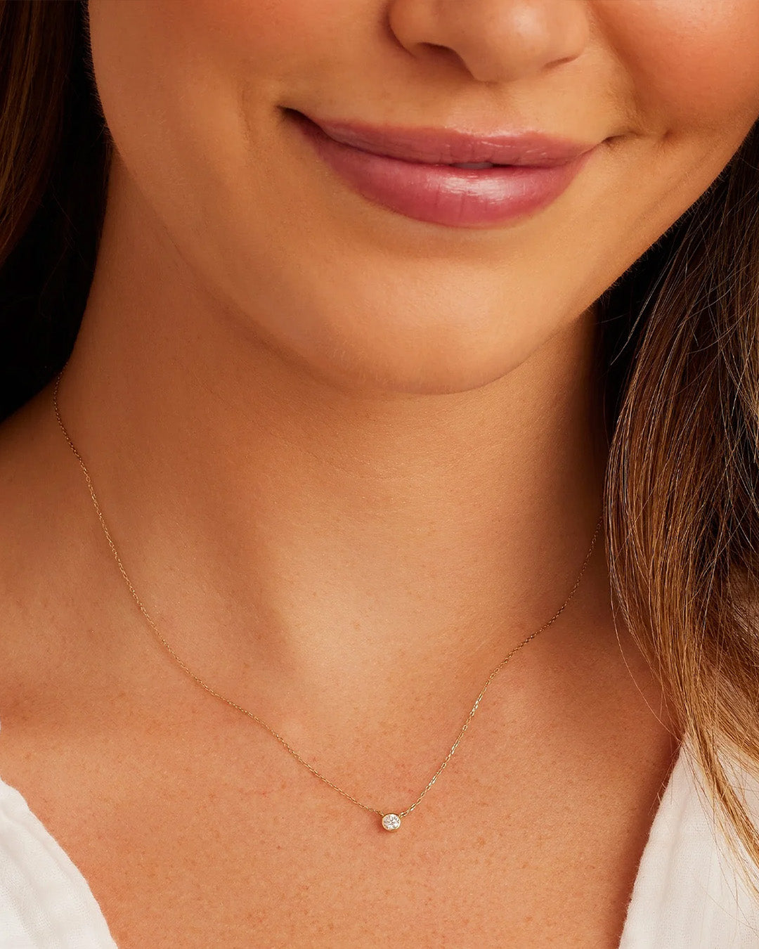 Classic Diamond Necklace featuring a solitaire bezel set diamond in 14k gold, showcasing elegance and sophistication.