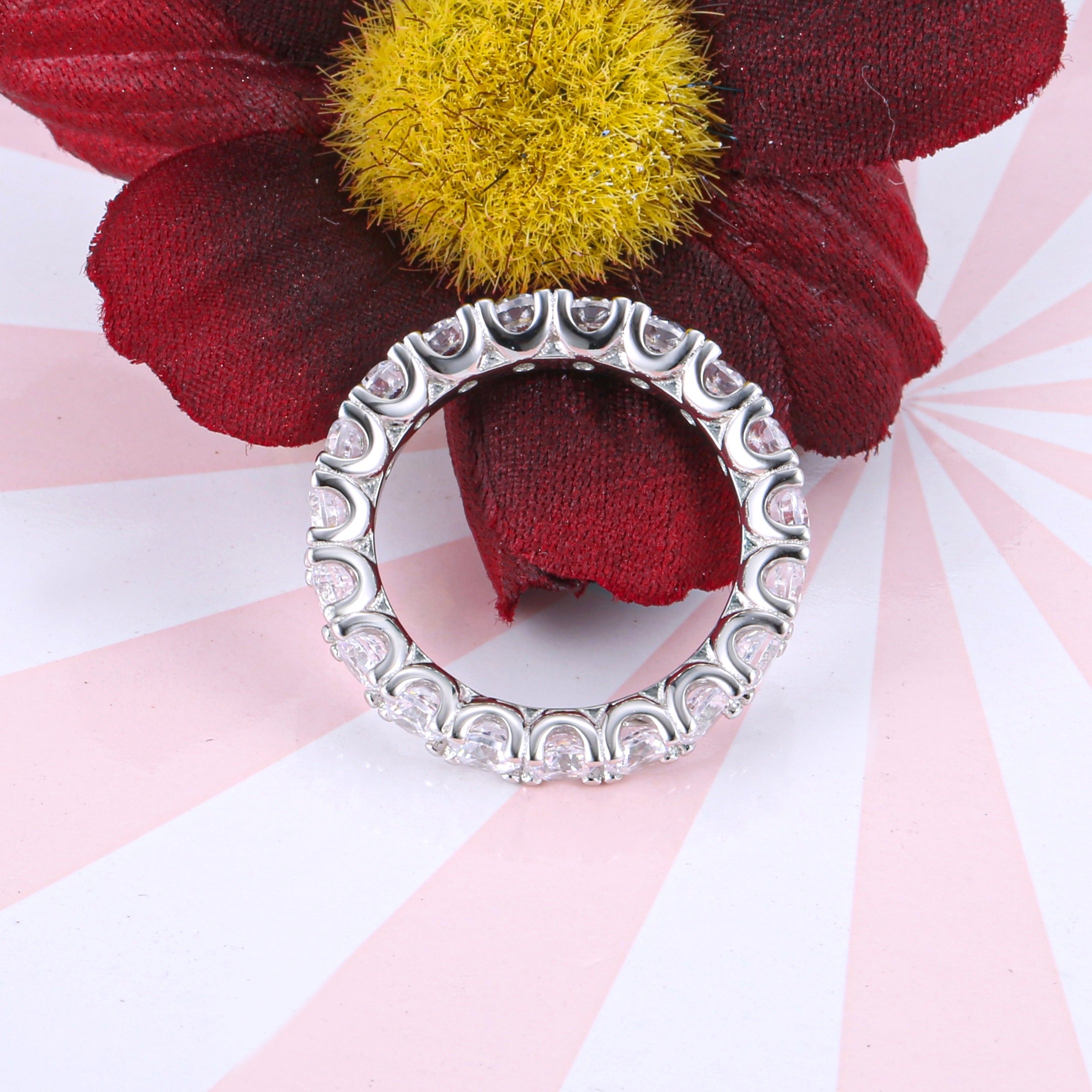 Classic Eternity Round Cut Women's Wedding Band made of sterling silver with white gold surface and white sapphires, showcasing elegance and durability.