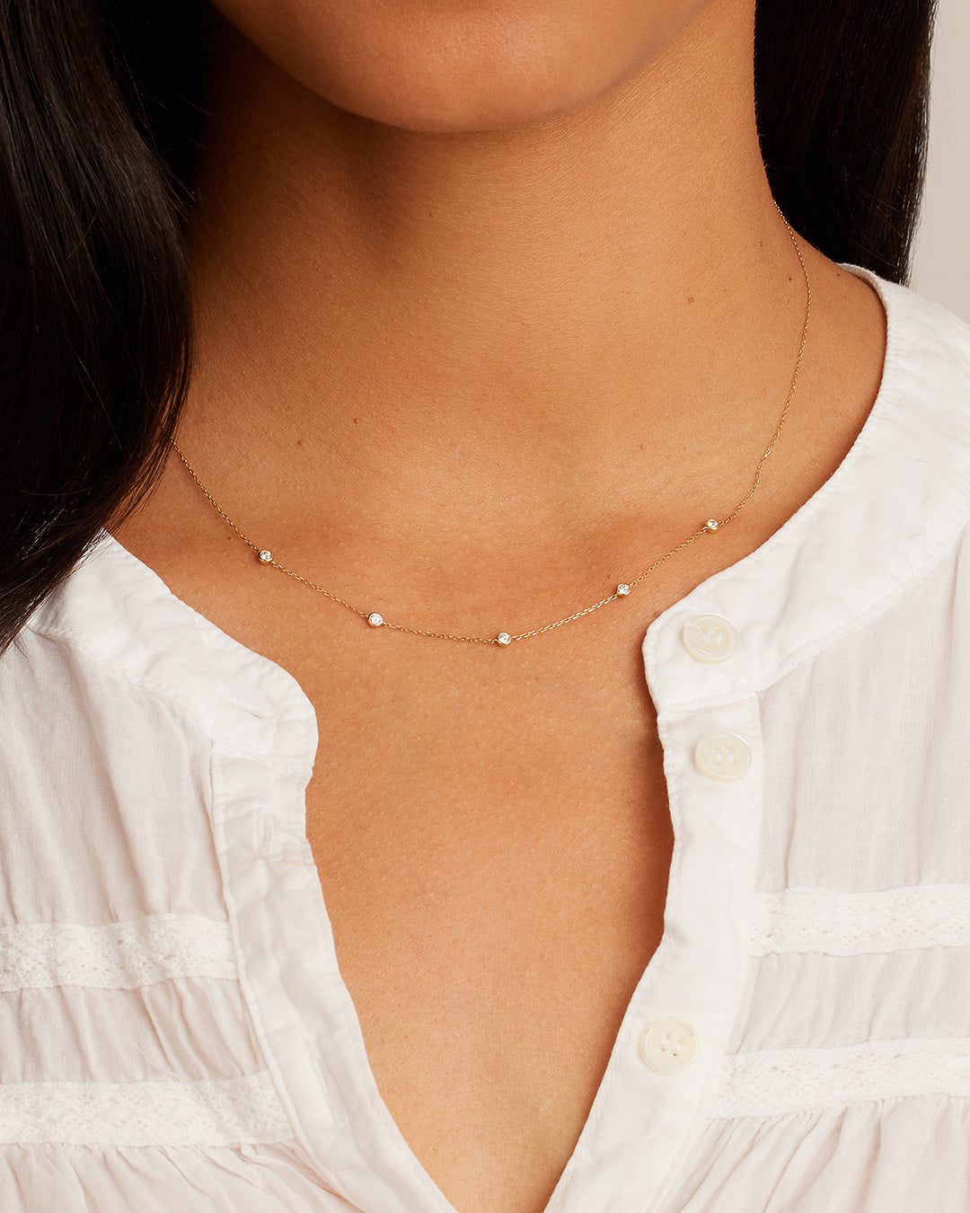 A classic five diamond necklace featuring five sparkling lab-grown diamonds set in a delicate metal chain, showcasing elegance and sophistication.