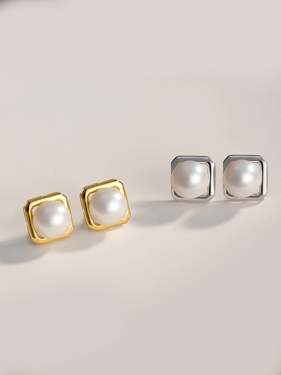 Classic Freshwater Pearl Stud Earrings featuring natural pearls set in sterling silver and gold vermeil, elegantly displayed in a jewelry pouch.