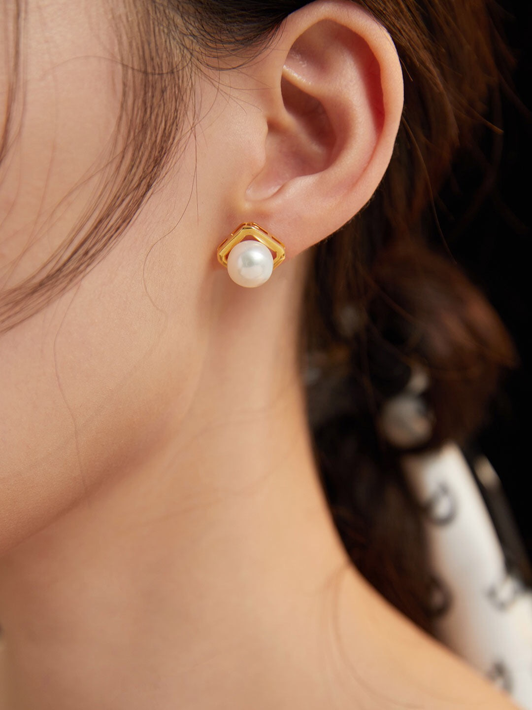 Classic Freshwater Pearl Stud Earrings featuring natural pearls set in sterling silver and gold vermeil, elegantly displayed in a jewelry pouch.