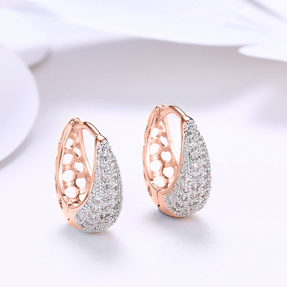 Classic teardrop huggie earrings in 18K rose gold plating, elegantly designed for comfort and style.