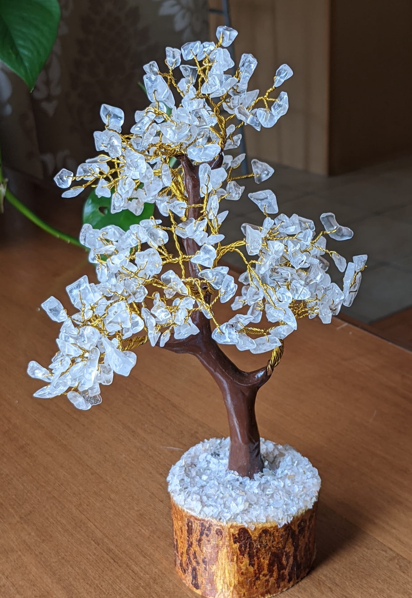 A beautifully handcrafted Clear Quartz Gemstone Tree featuring 300 natural quartz chips on a sturdy wooden base, standing 8-9 inches tall.