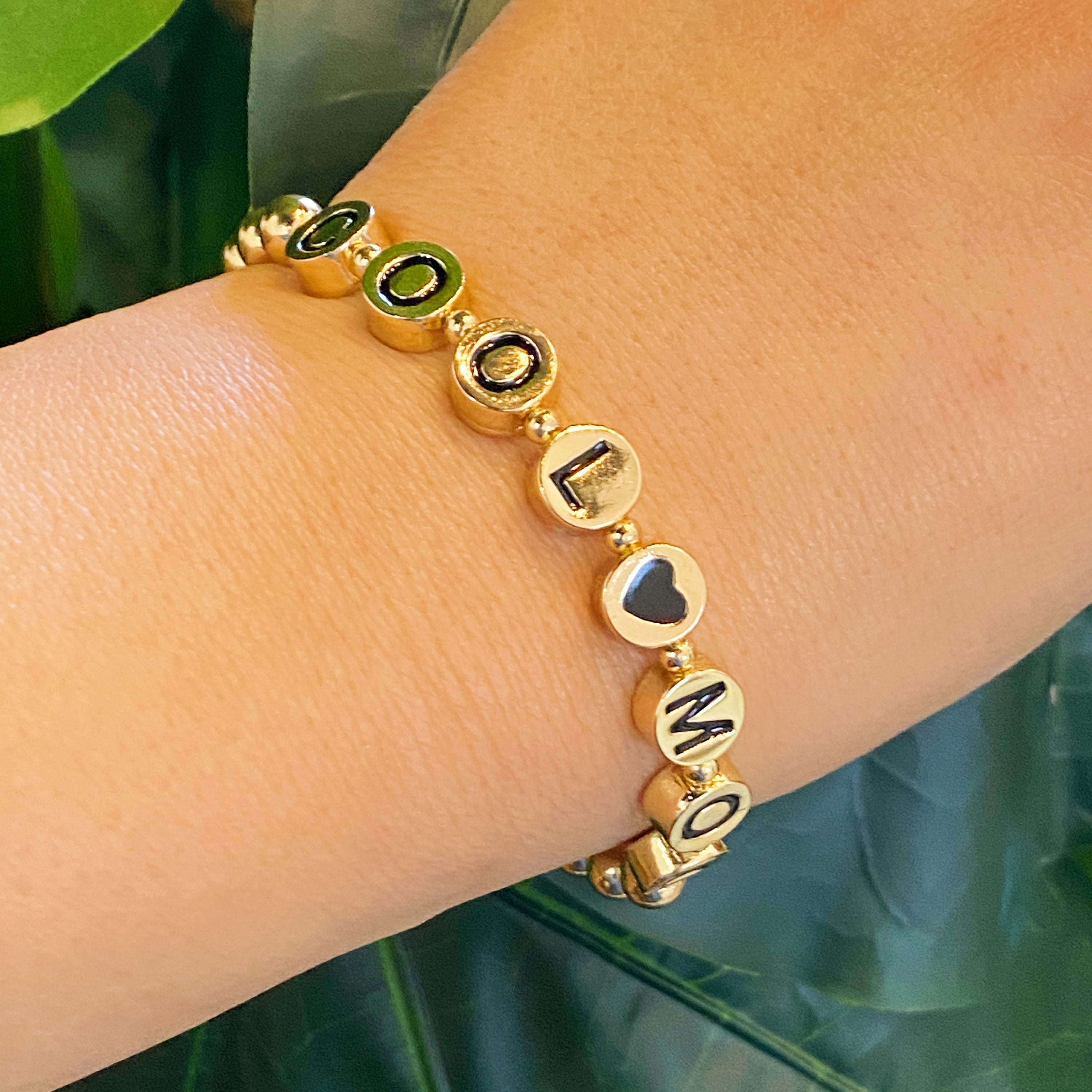 Cool Mom Gold Bead Bracelet featuring gold tone ball beads and black letter beads, showcasing a stylish and personalized design.