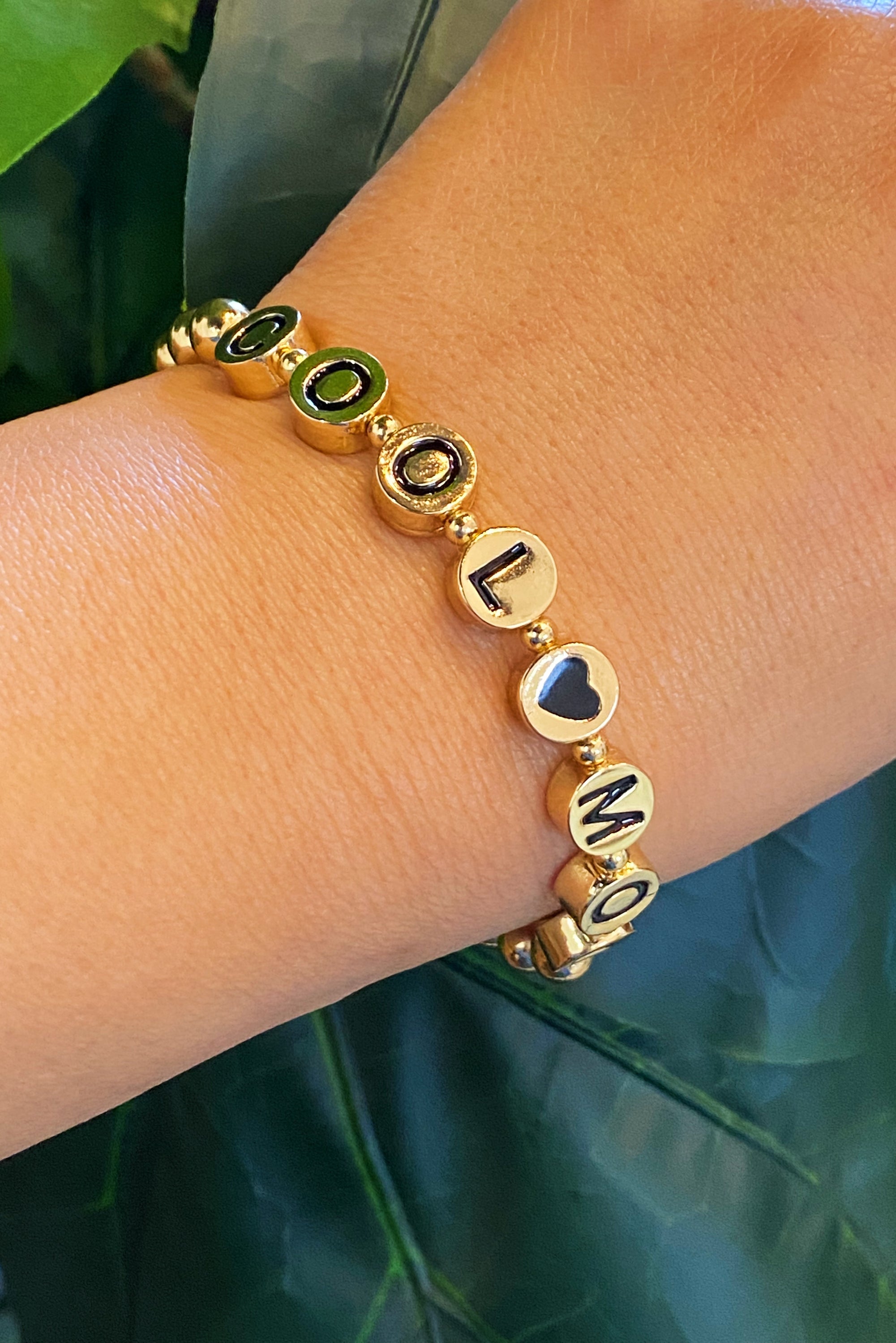 Cool Mom Gold Bead Bracelet featuring gold tone ball beads and black letter beads, showcasing a stylish and personalized design.