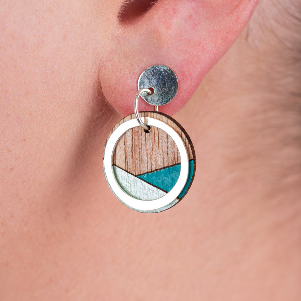 Conture Recycled Wood Silver Earrings showcasing unique wood patterns and sterling silver backing, available in six colors.