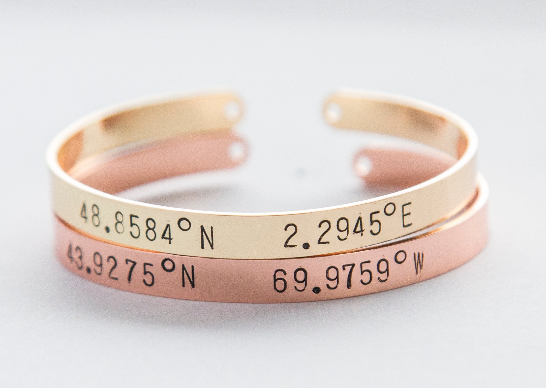 A beautiful adjustable Coordinates bracelet in gold and silver plating, showcasing a unique hand-stamped design.