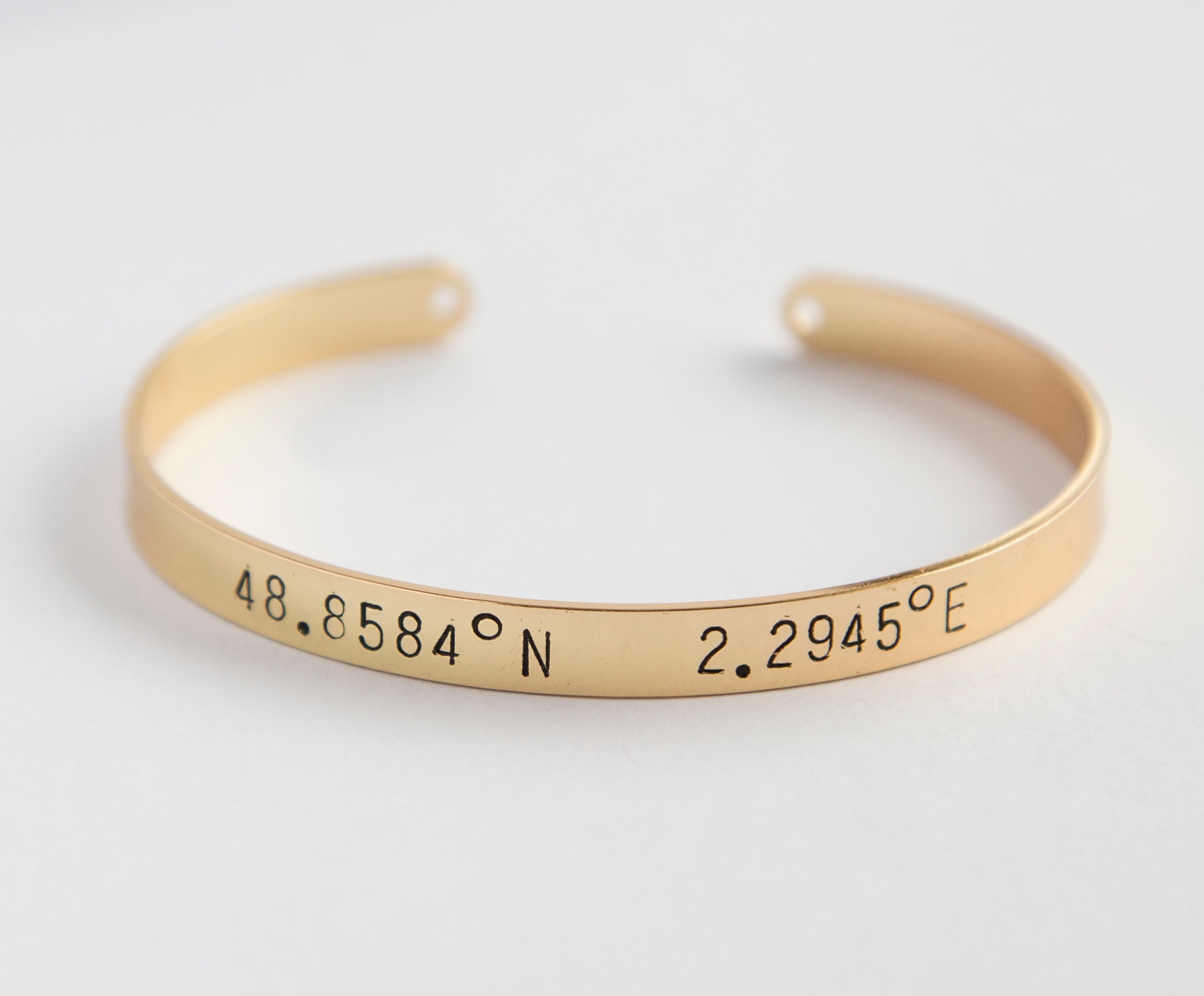 A beautiful adjustable Coordinates bracelet in gold and silver plating, showcasing a unique hand-stamped design.