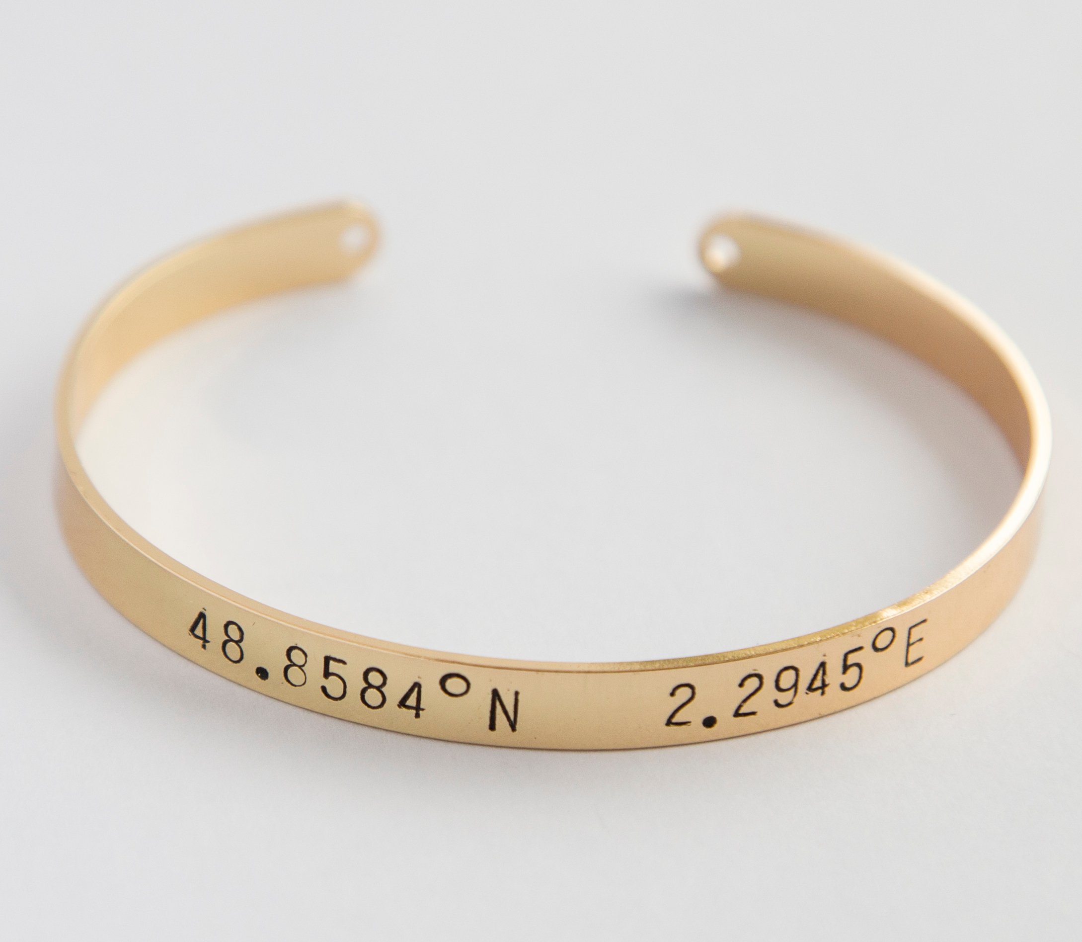 A beautiful adjustable Coordinates bracelet in gold and silver plating, showcasing a unique hand-stamped design.