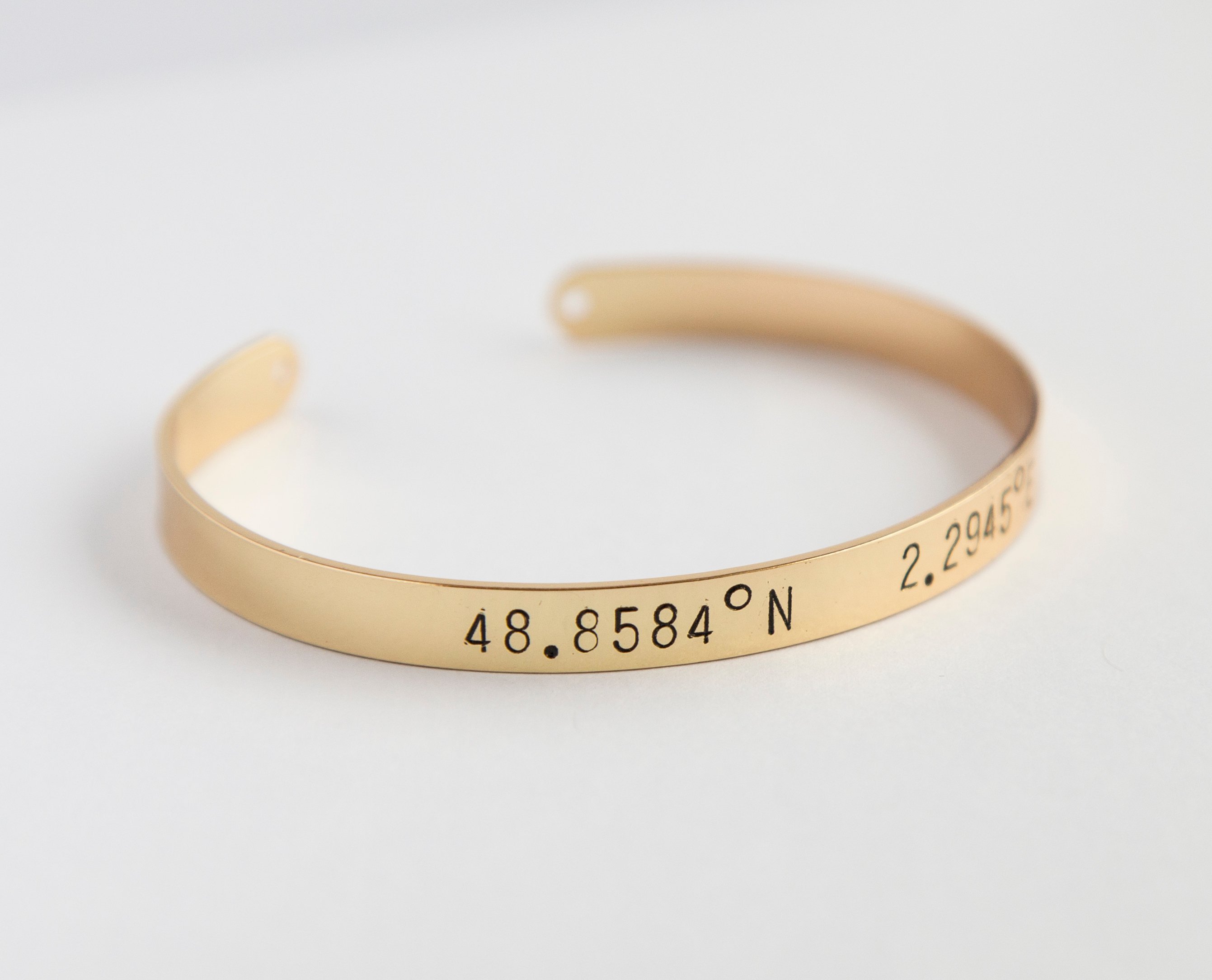 A beautiful adjustable Coordinates bracelet in gold and silver plating, showcasing a unique hand-stamped design.