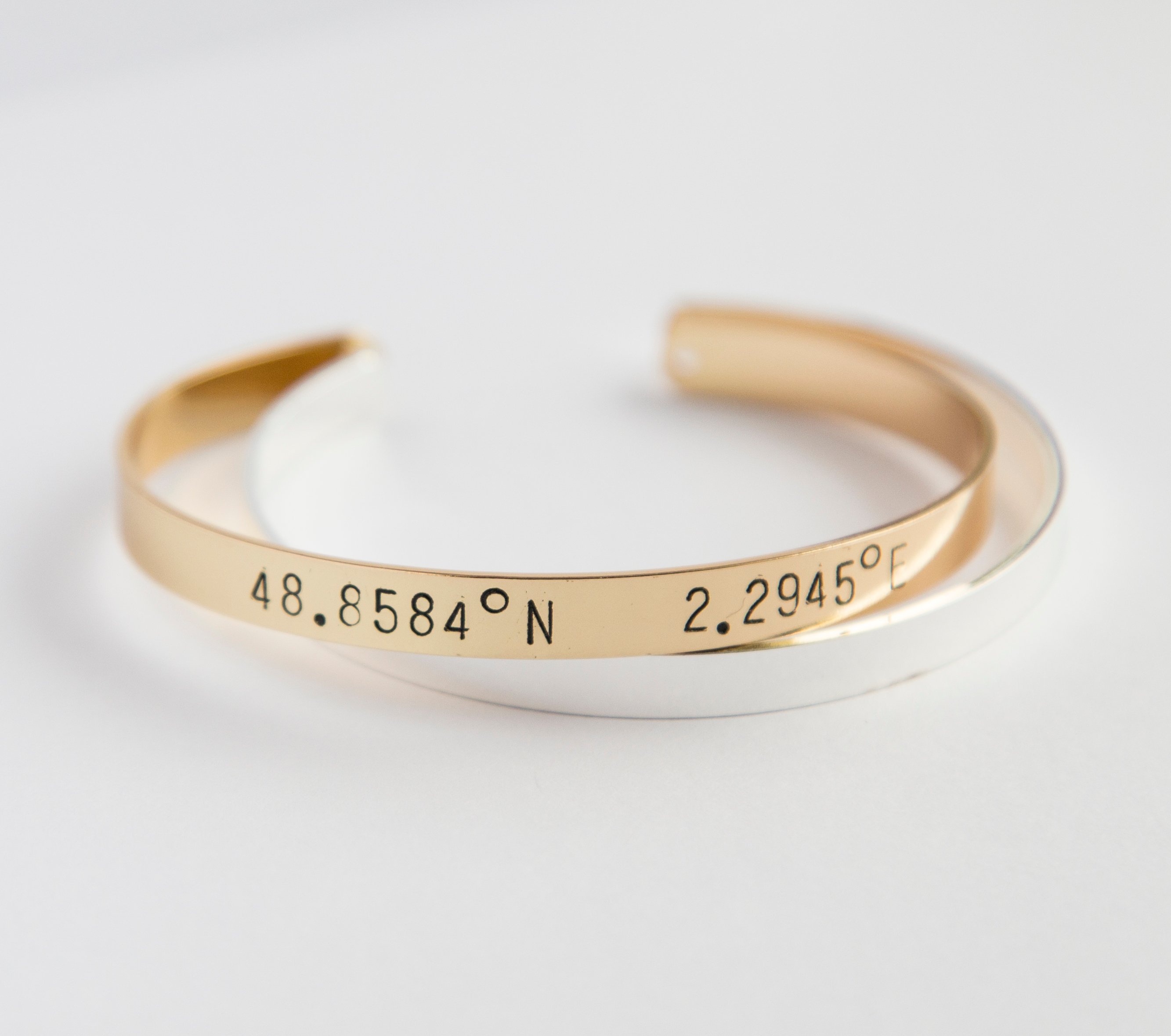 A beautiful adjustable Coordinates bracelet in gold and silver plating, showcasing a unique hand-stamped design.