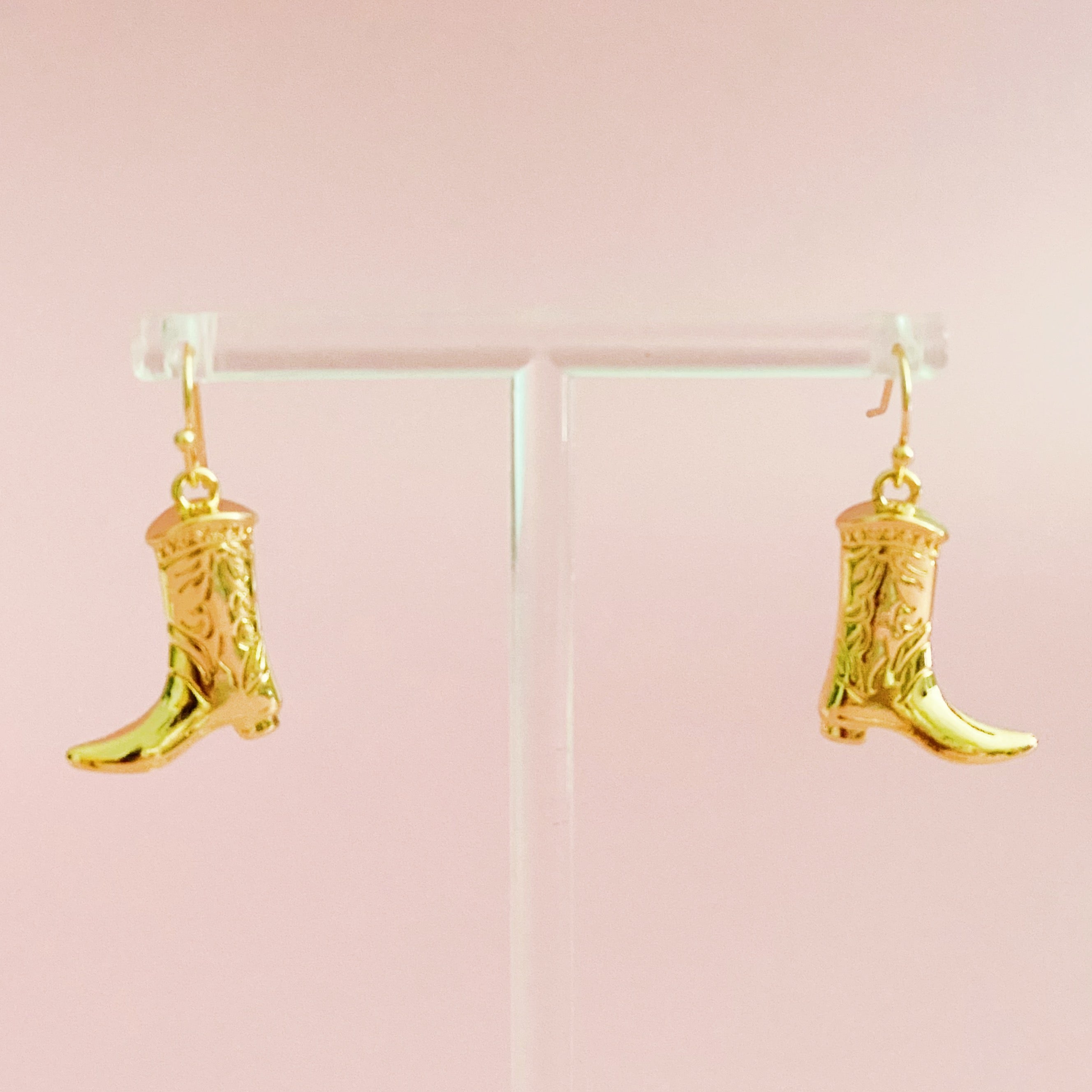 A pair of stylish Cowgirl Bootie Dangle Earrings featuring detailed boot charms on fishhook design, perfect for western-inspired fashion.