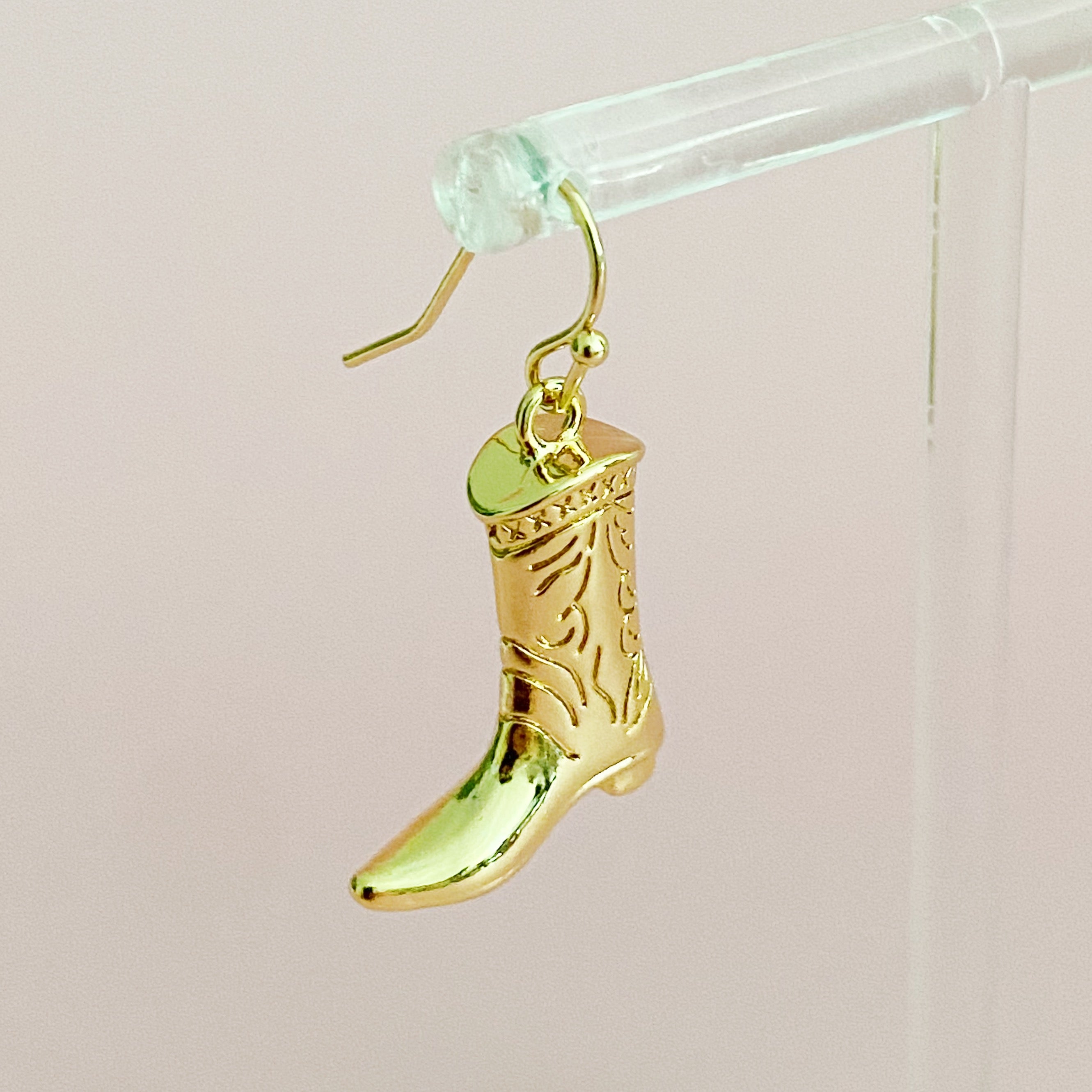 A pair of stylish Cowgirl Bootie Dangle Earrings featuring detailed boot charms on fishhook design, perfect for western-inspired fashion.