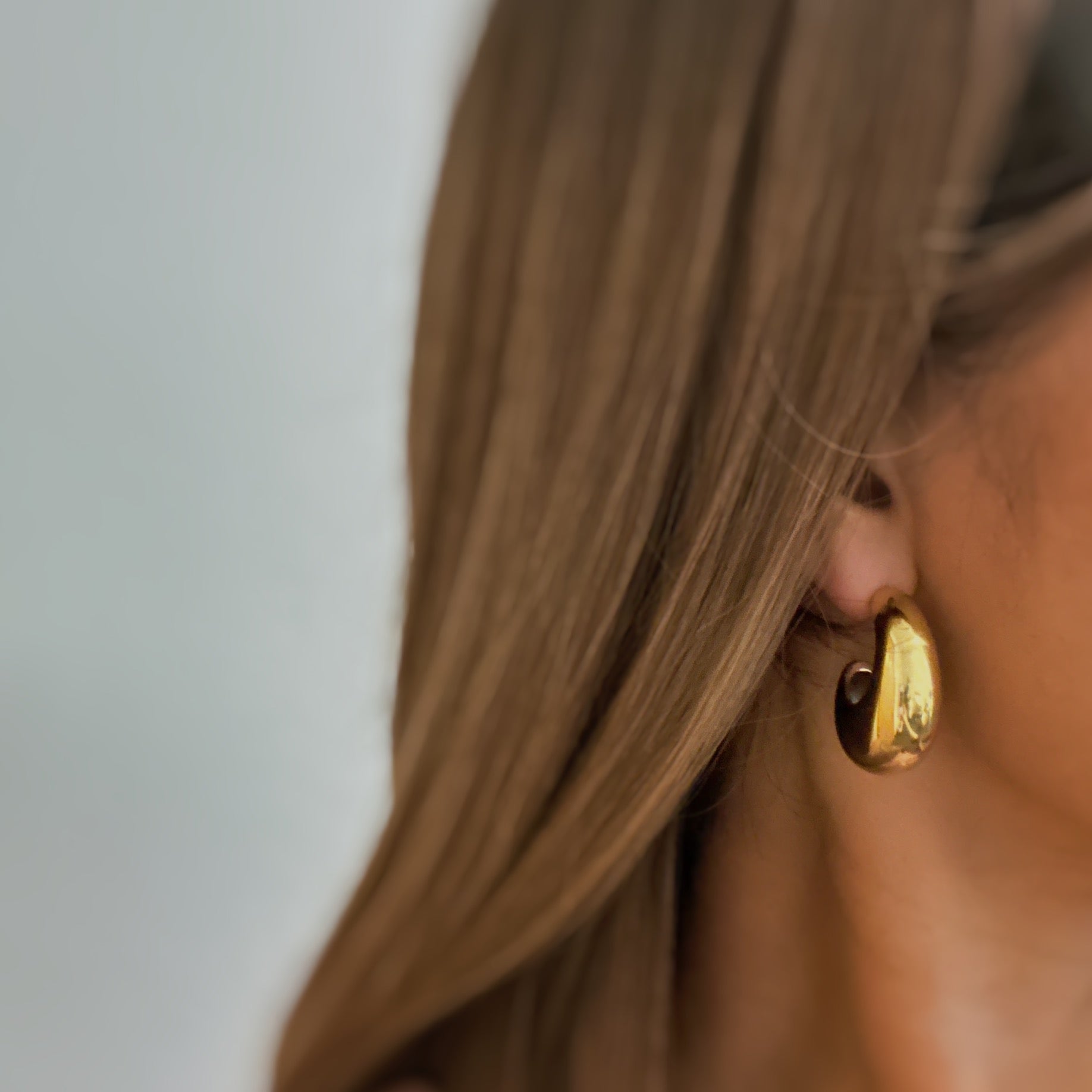 Crescent Halo Golden Hoop Earrings showcasing a unique crescent shape design in 18k gold plated stainless steel.