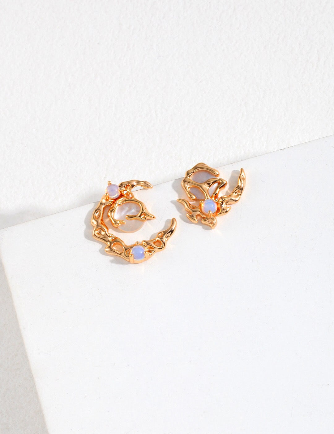 Crescent Moon Style Asymmetrical Opal Stud Earrings featuring opal and mother of pearl, set in sterling silver and gold vermeil.