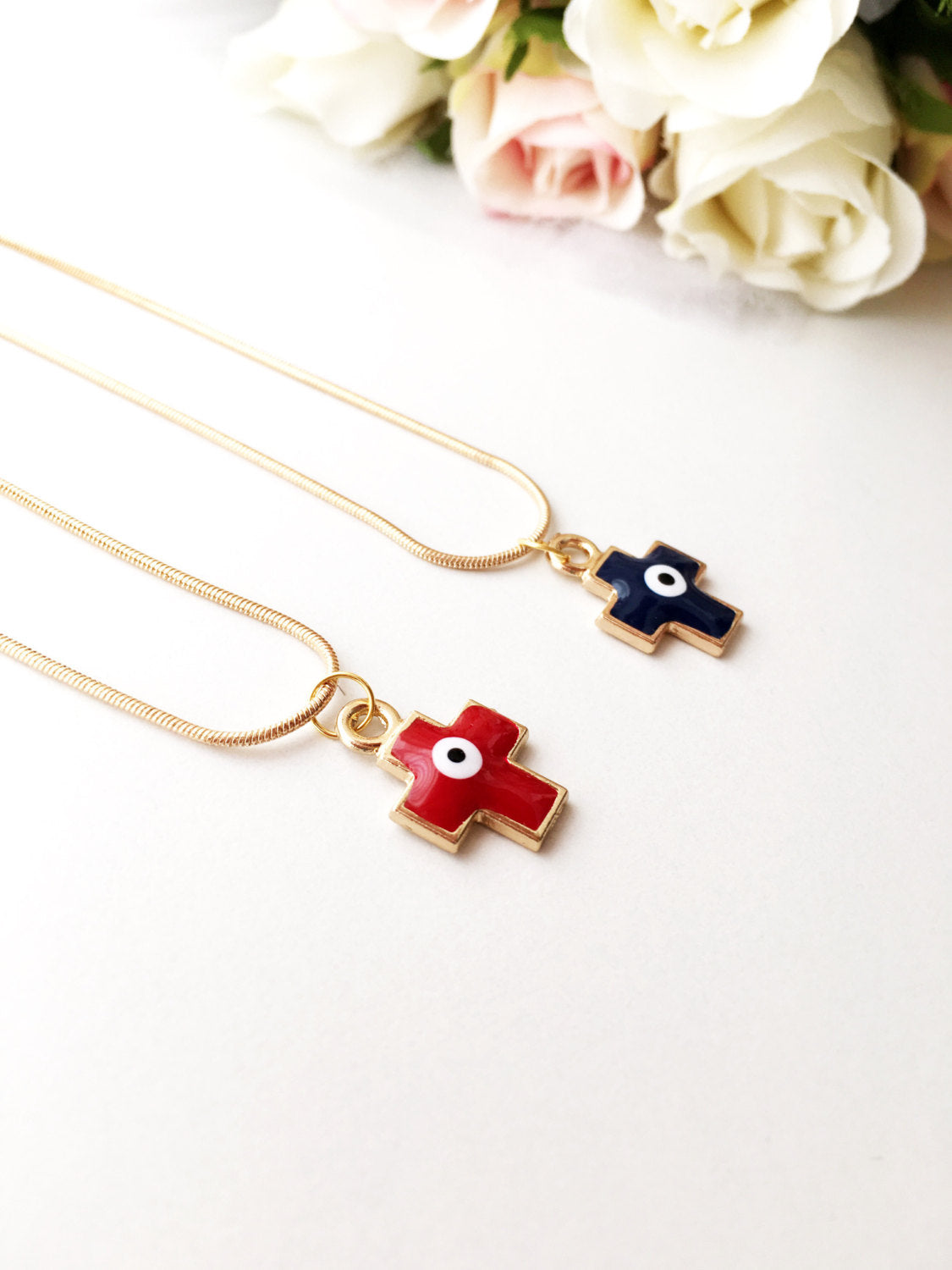 Handmade Cross Evil Eye Necklace featuring a blue and red charm on a gold plated chain.