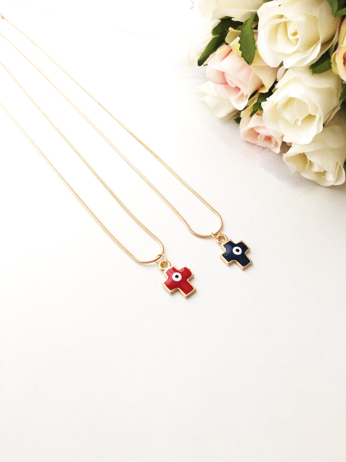 Handmade Cross Evil Eye Necklace featuring a blue and red charm on a gold plated chain.