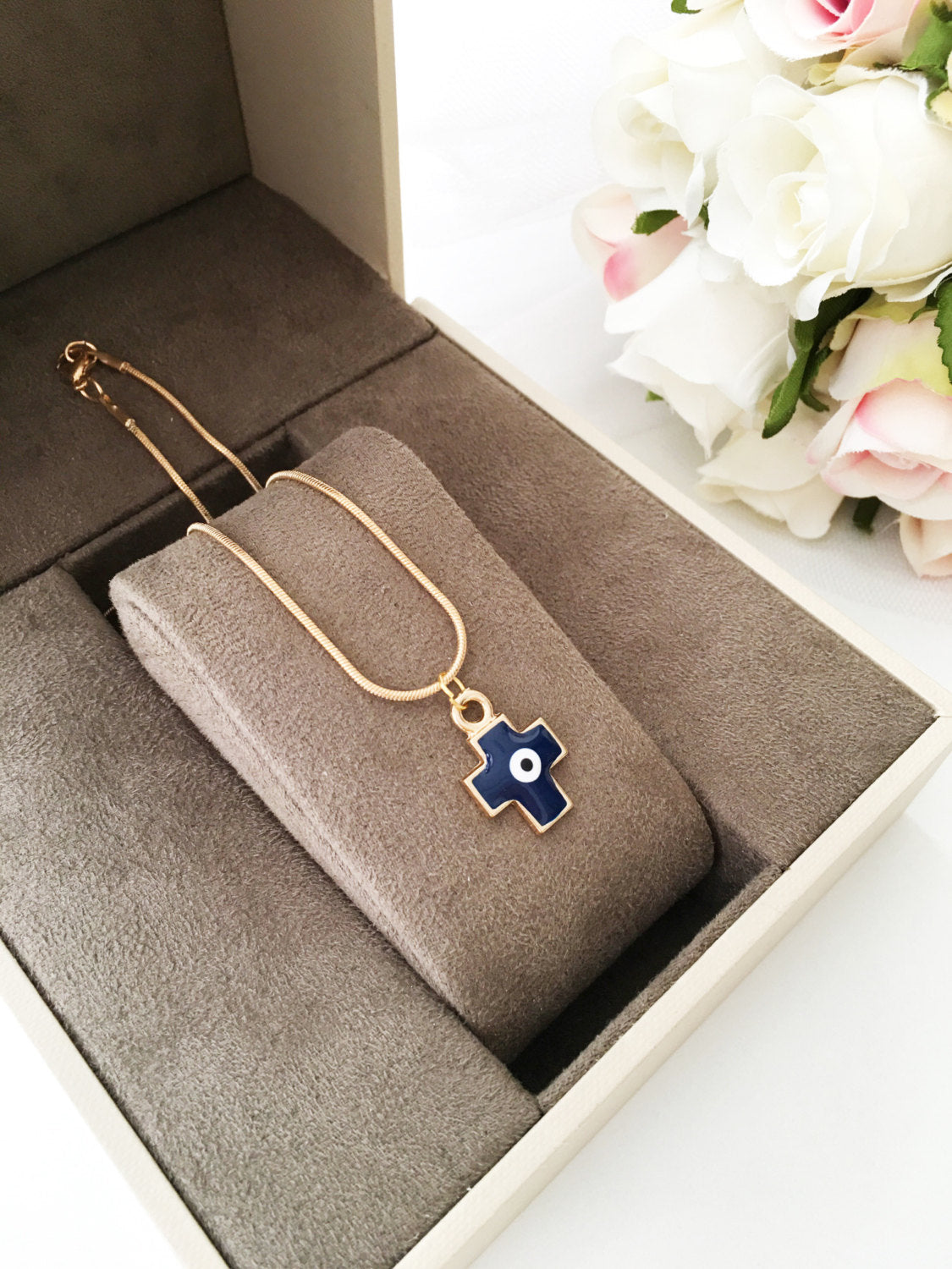 Handmade Cross Evil Eye Necklace featuring a blue and red charm on a gold plated chain.