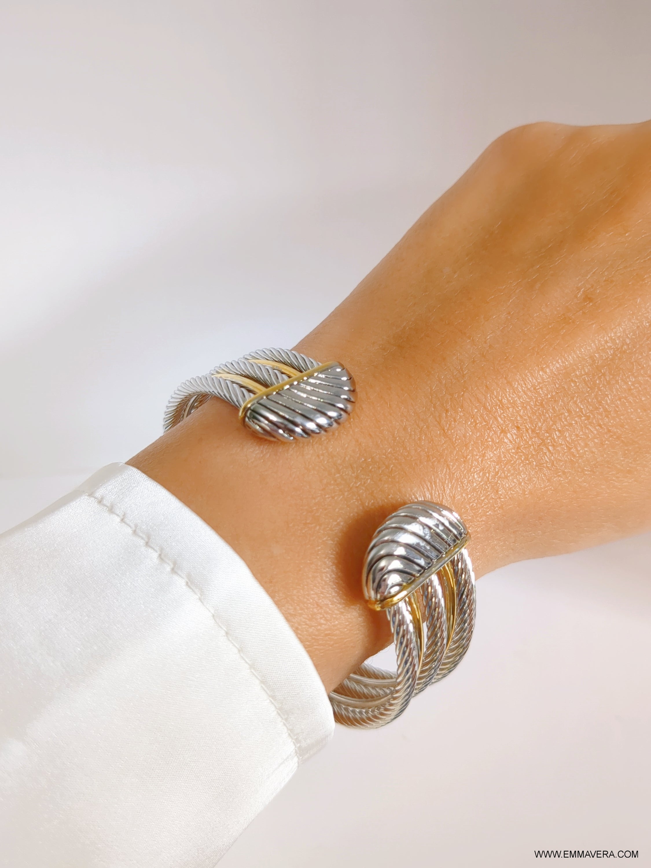 Elegant Cross Over Large Two Tone Bangle Bracelet featuring a unique cable design with gold accents, showcasing its stylish and modern appeal.