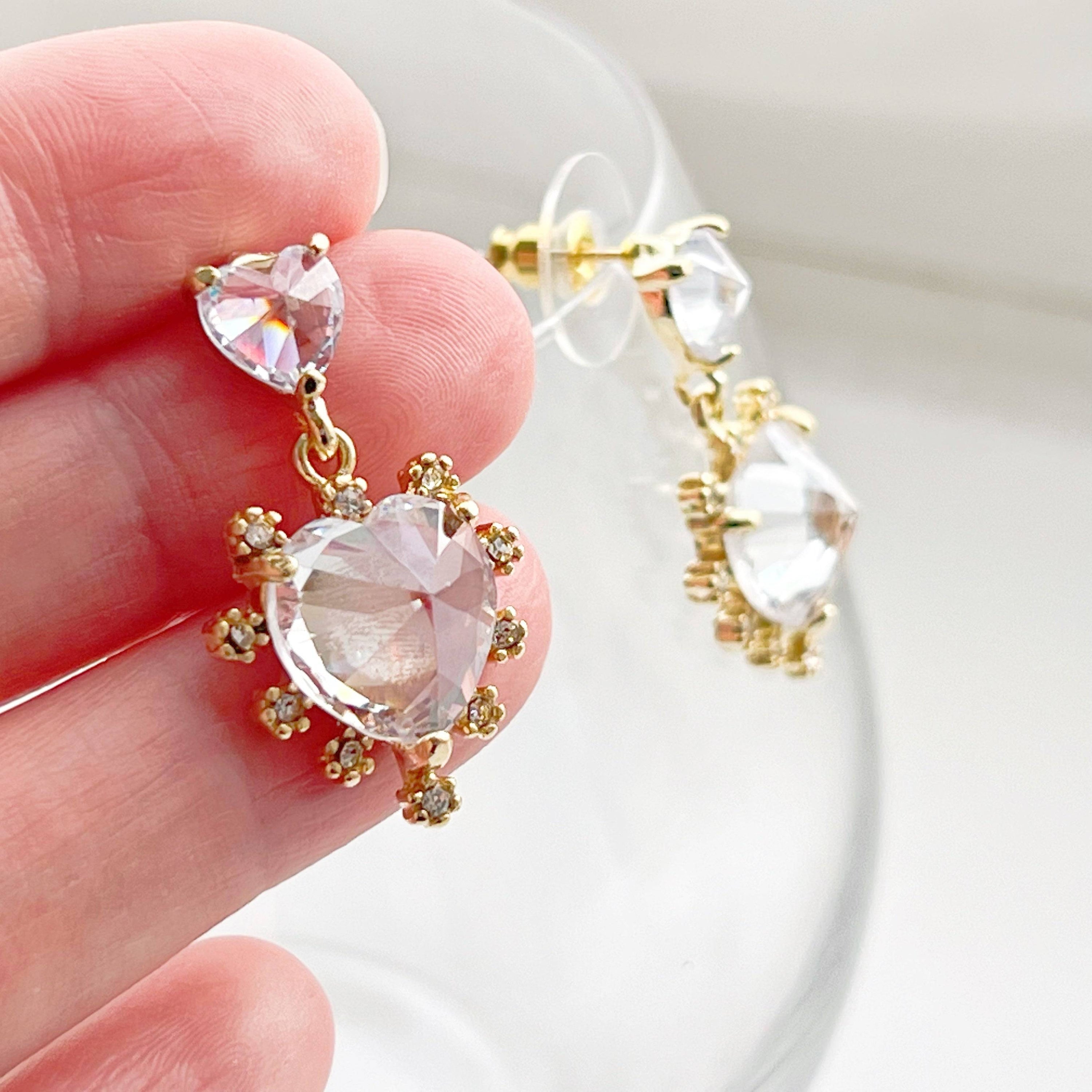 Elegant Crystal Clear Double Hearts Drop Earrings made of sterling silver with gold-coated bronze and crystal accents, beautifully displayed in a gift box.