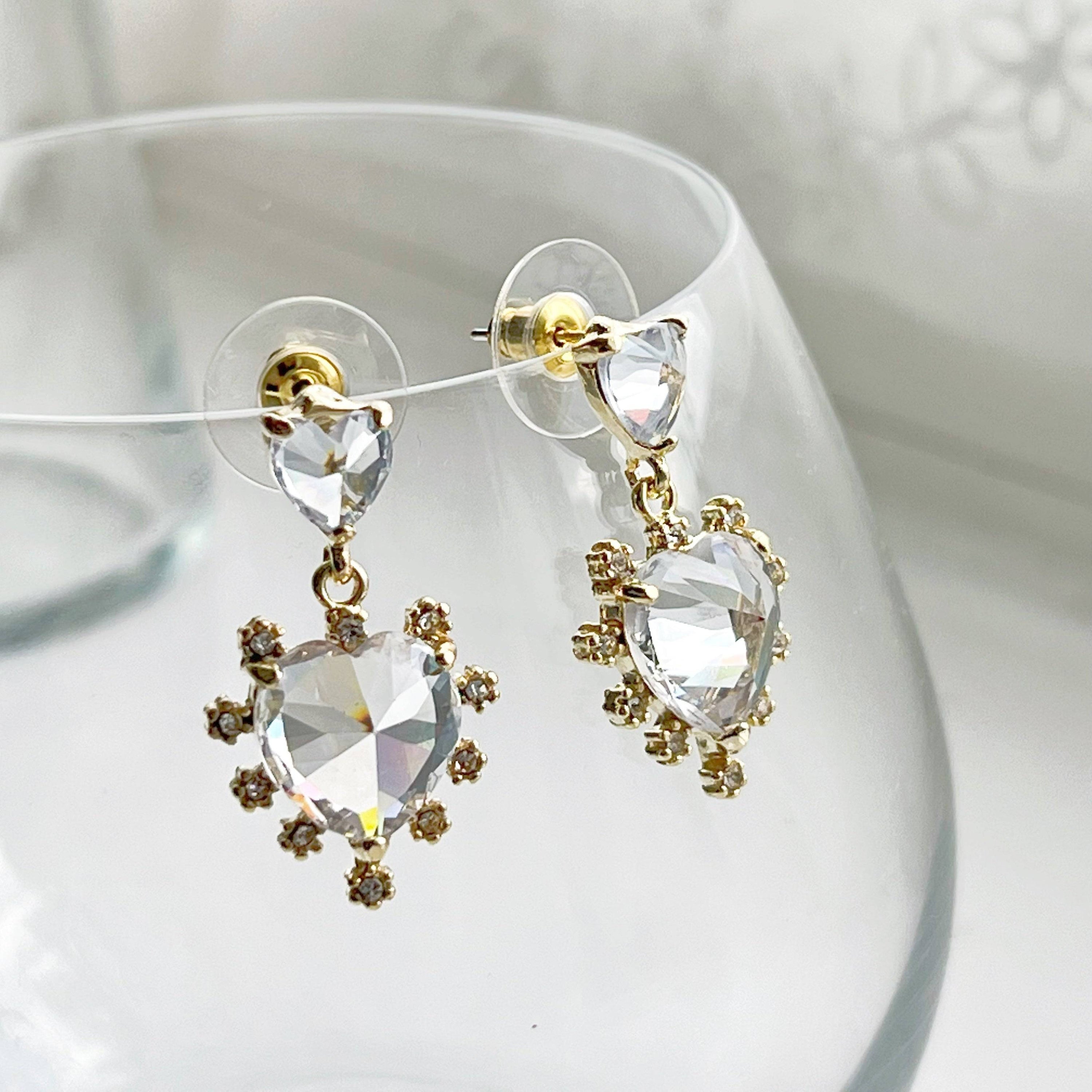 Elegant Crystal Clear Double Hearts Drop Earrings made of sterling silver with gold-coated bronze and crystal accents, beautifully displayed in a gift box.