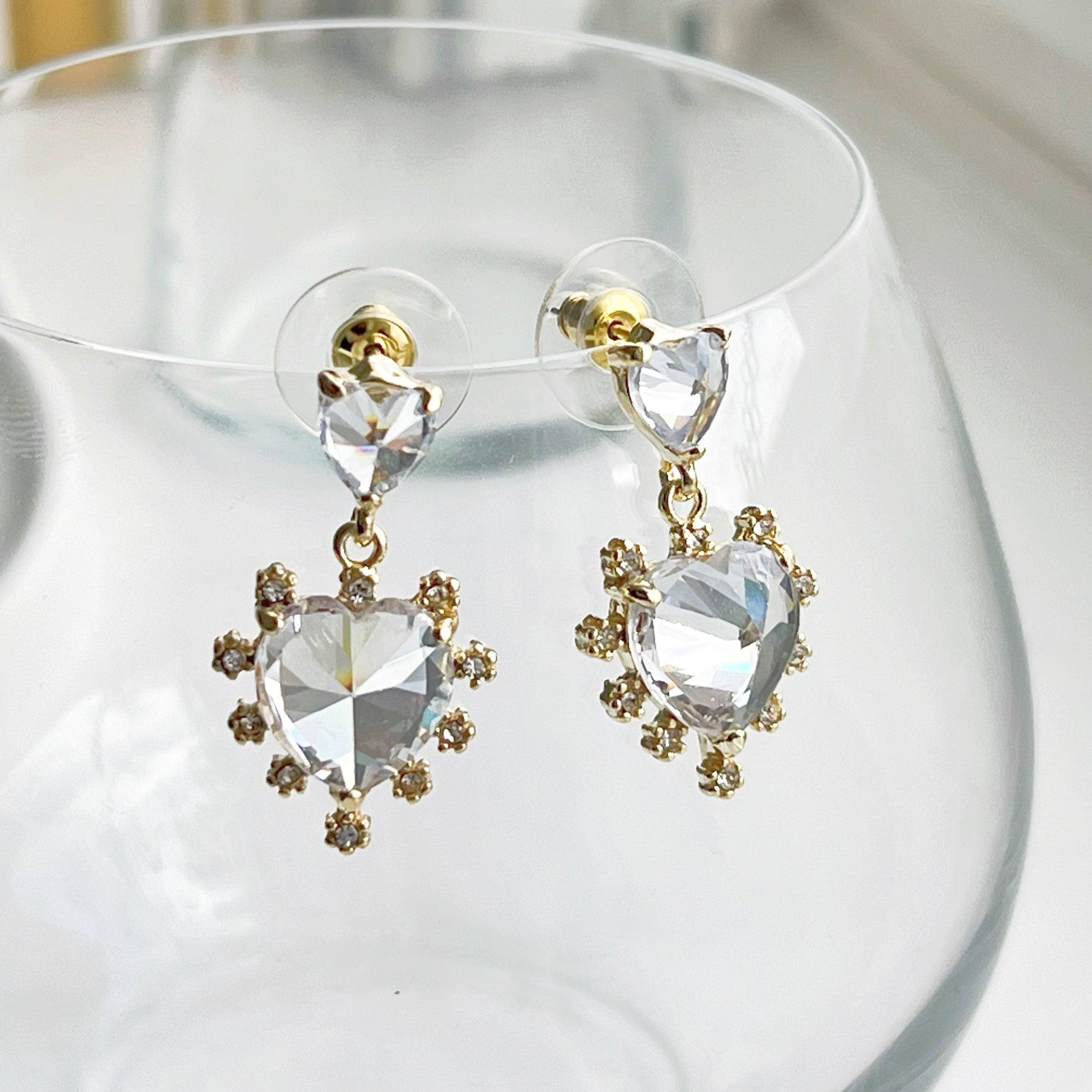 Elegant Crystal Clear Double Hearts Drop Earrings made of sterling silver with gold-coated bronze and crystal accents, beautifully displayed in a gift box.