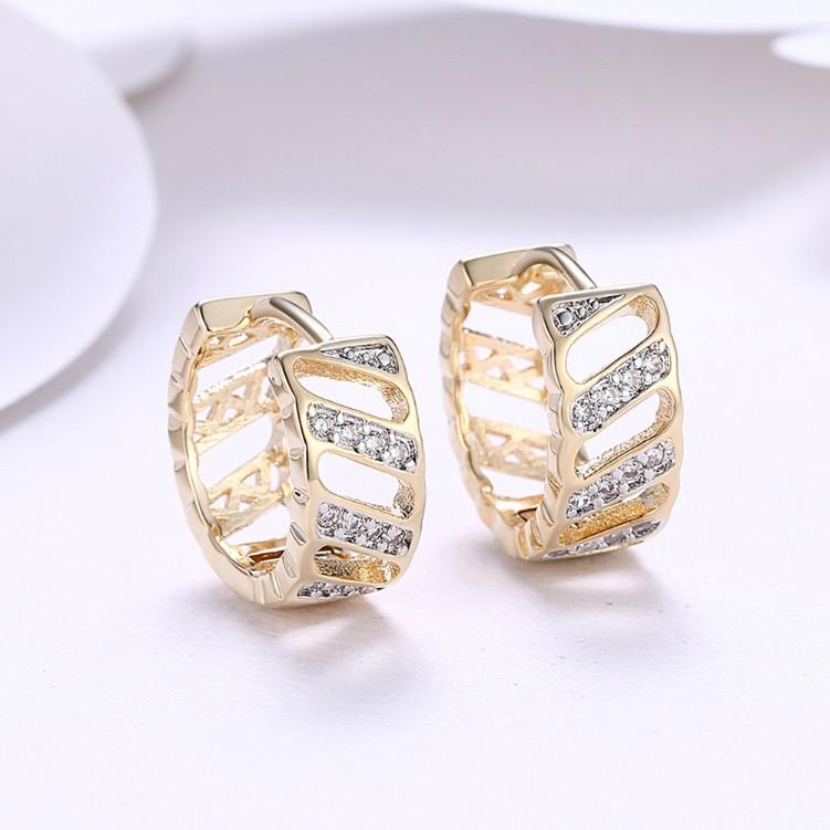 Elegant Crystal Curved Hollow Huggies in 18K Gold, showcasing their unique design and sparkling crystals.