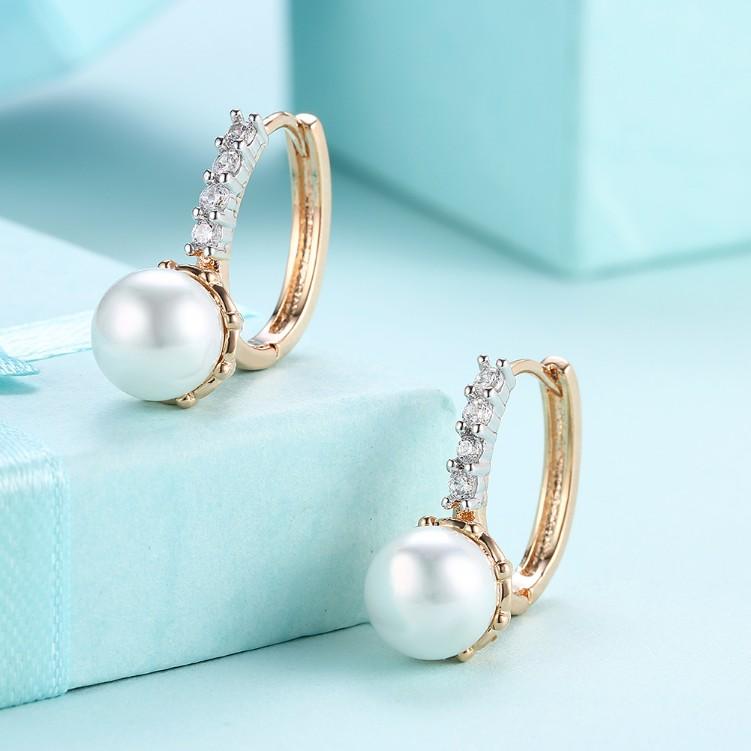 Elegant Crystal Curved Pav'e Pearl Huggie Earrings set in 18K gold, showcasing sparkling crystals and a butterfly backing.