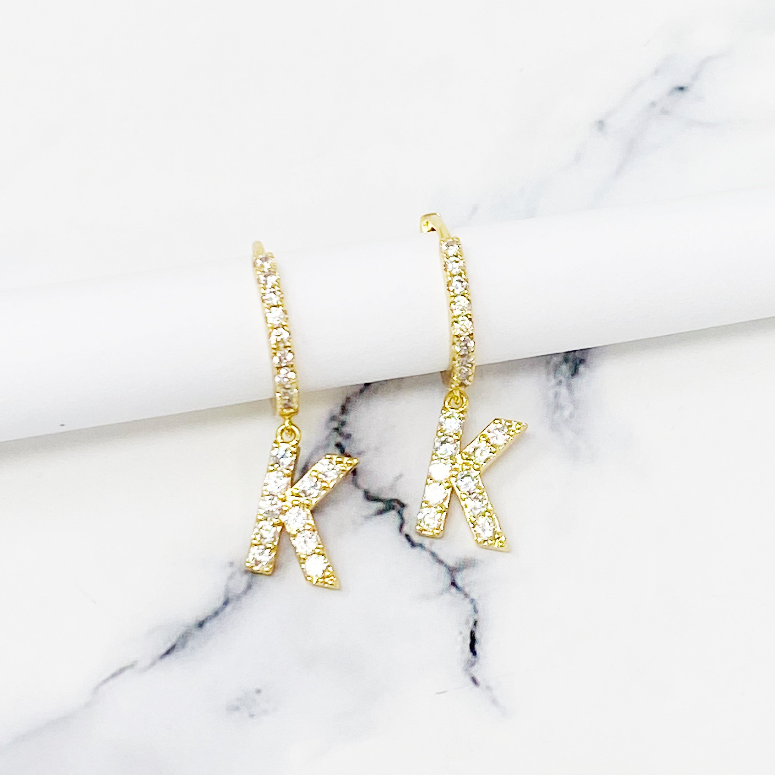 Elegant Crystal Initial Drop Earrings featuring a shiny hoop and sparkling initial charm, perfect for everyday wear.