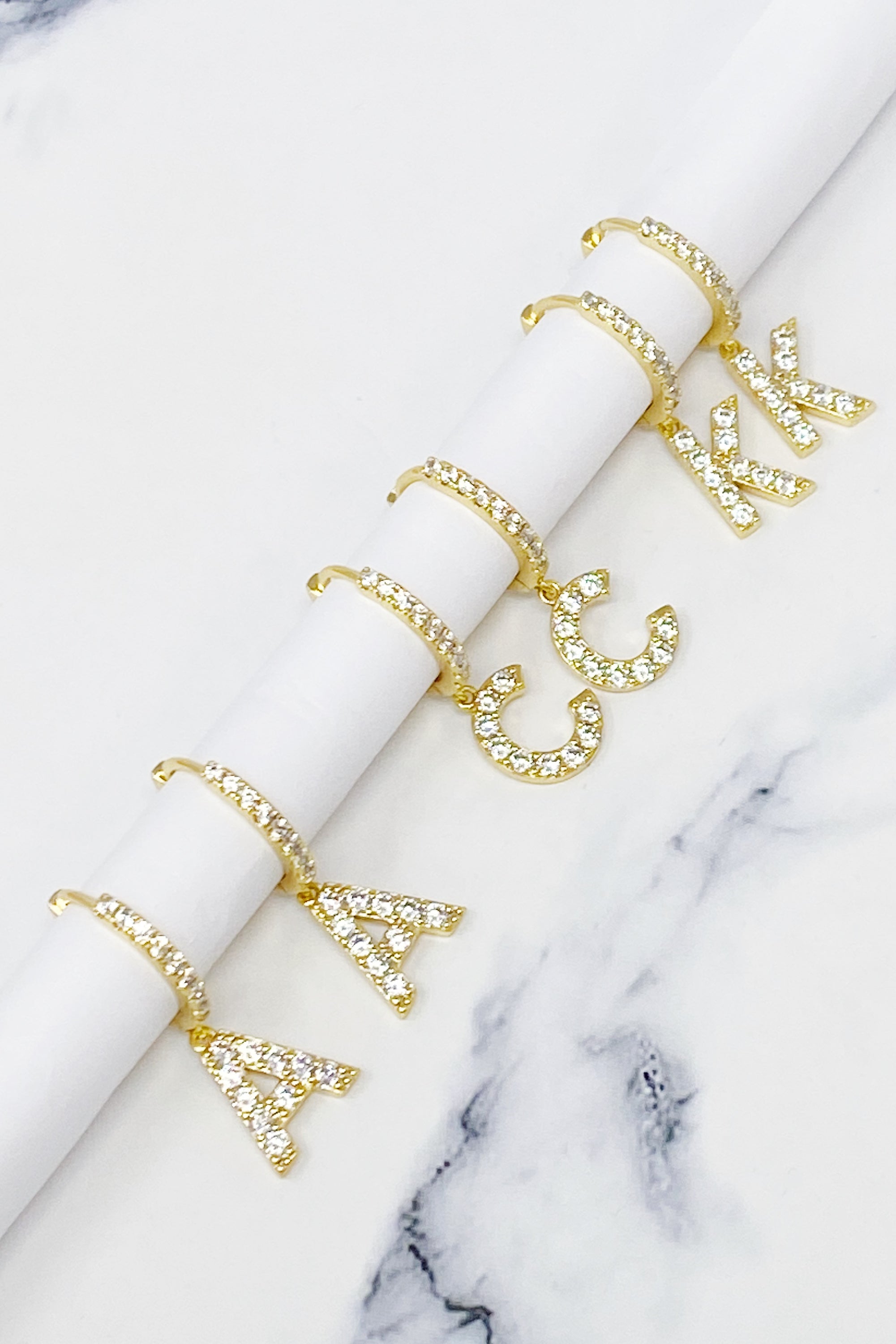 Elegant Crystal Initial Drop Earrings featuring a shiny hoop and sparkling initial charm, perfect for everyday wear.