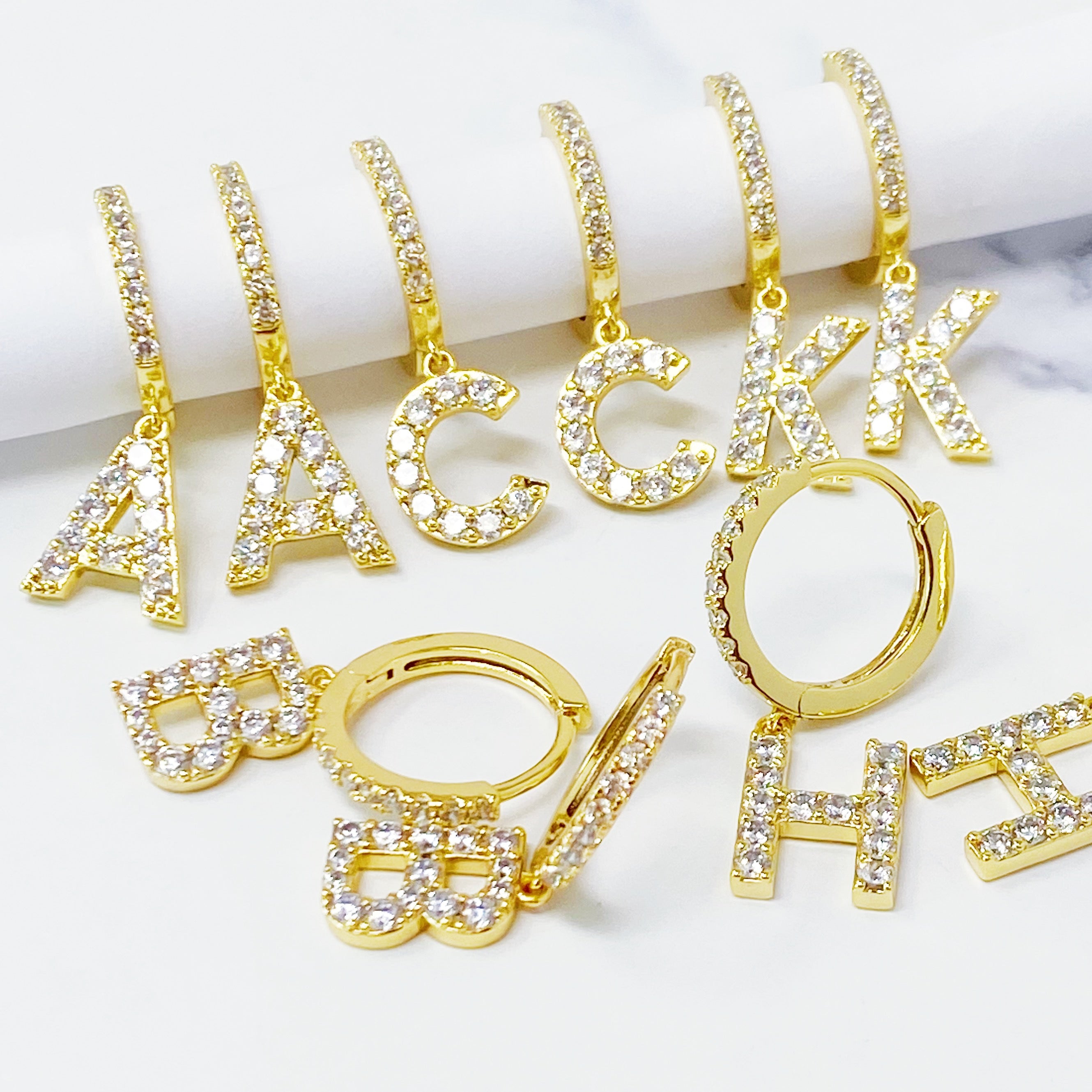 Elegant Crystal Initial Drop Earrings featuring a shiny hoop and sparkling initial charm, perfect for everyday wear.