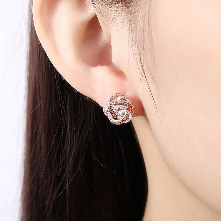 Elegant rose gold crystal knot stud earrings, featuring a butterfly backing and hypoallergenic design, perfect for any occasion.