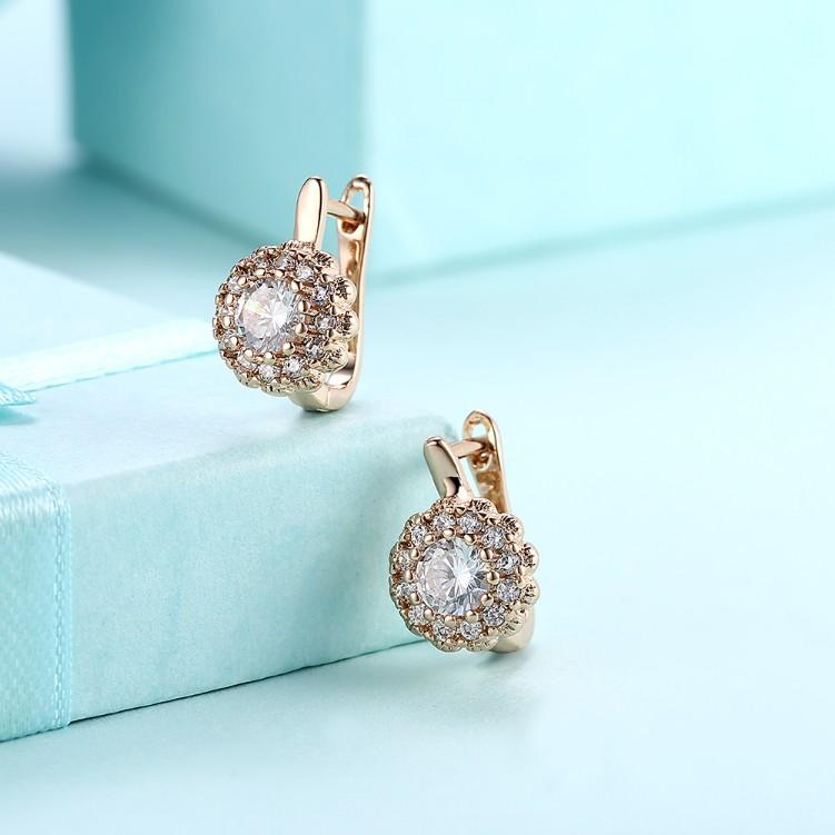 Elegant Crystal Micro Pav'e Bursting Star Leverback Earrings set in 18K gold, featuring sparkling crystals and a secure butterfly backing.