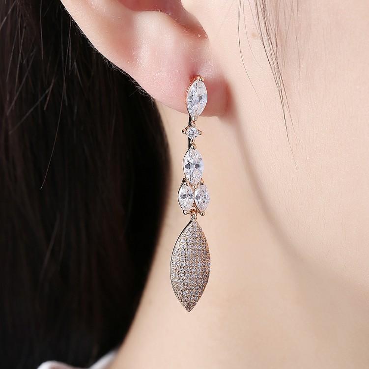 Elegant Crystal Micro-Pav'e Dangling Pear Shaped Earrings in 18K Gold, showcasing intricate detailing and sparkling crystals.