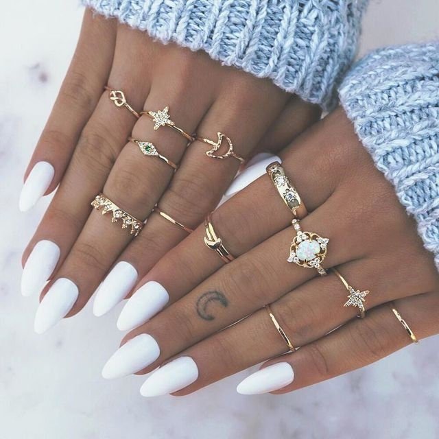 A beautiful set of 12 gold midi rings featuring geometric designs and crystal inlays, perfect for layering and styling.
