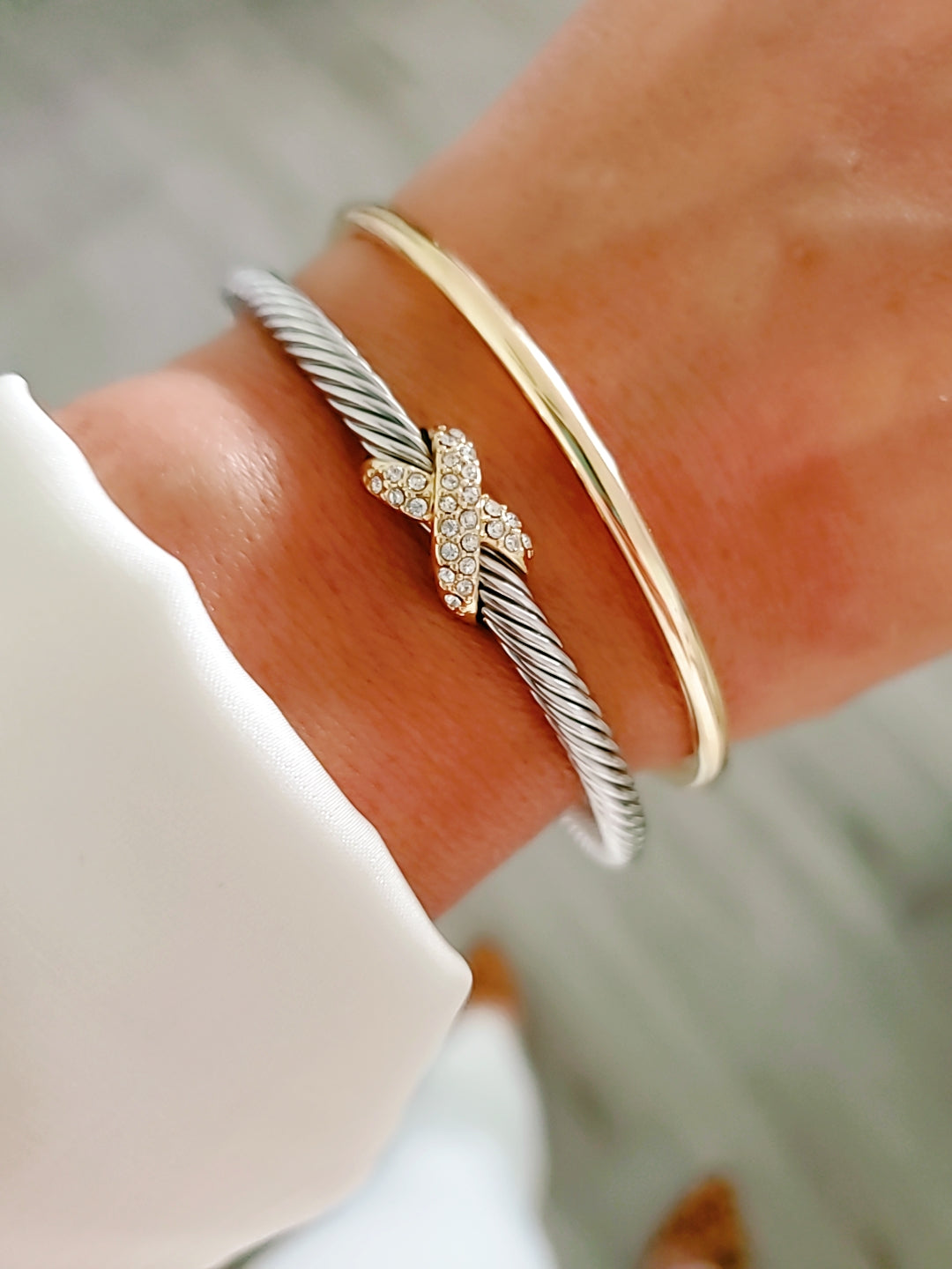 Elegant Crystals X Bangle Bracelet with 18K gold filled details and simulated diamonds, featuring a delicate cable pattern.