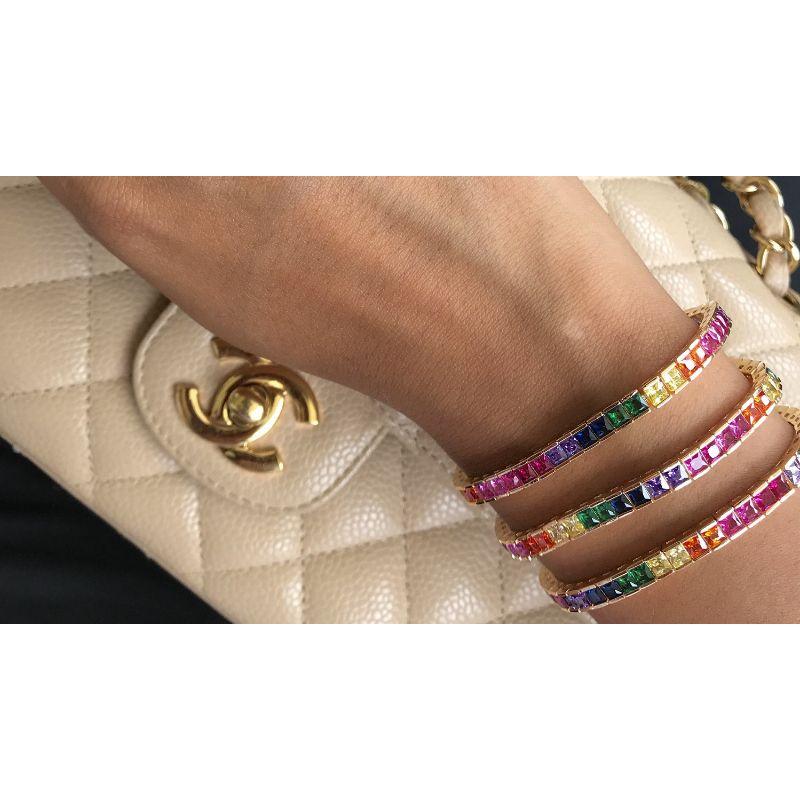 Cubic Zirconia Colorful Tennis Bracelet featuring gold plating and vibrant round cut stones, elegantly displayed on a soft surface.