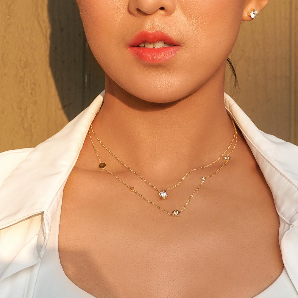 Cubic Zirconia Set featuring a necklace, bracelet, ring, and earrings, all crafted from stainless steel with sparkling cubic zirconia accents.